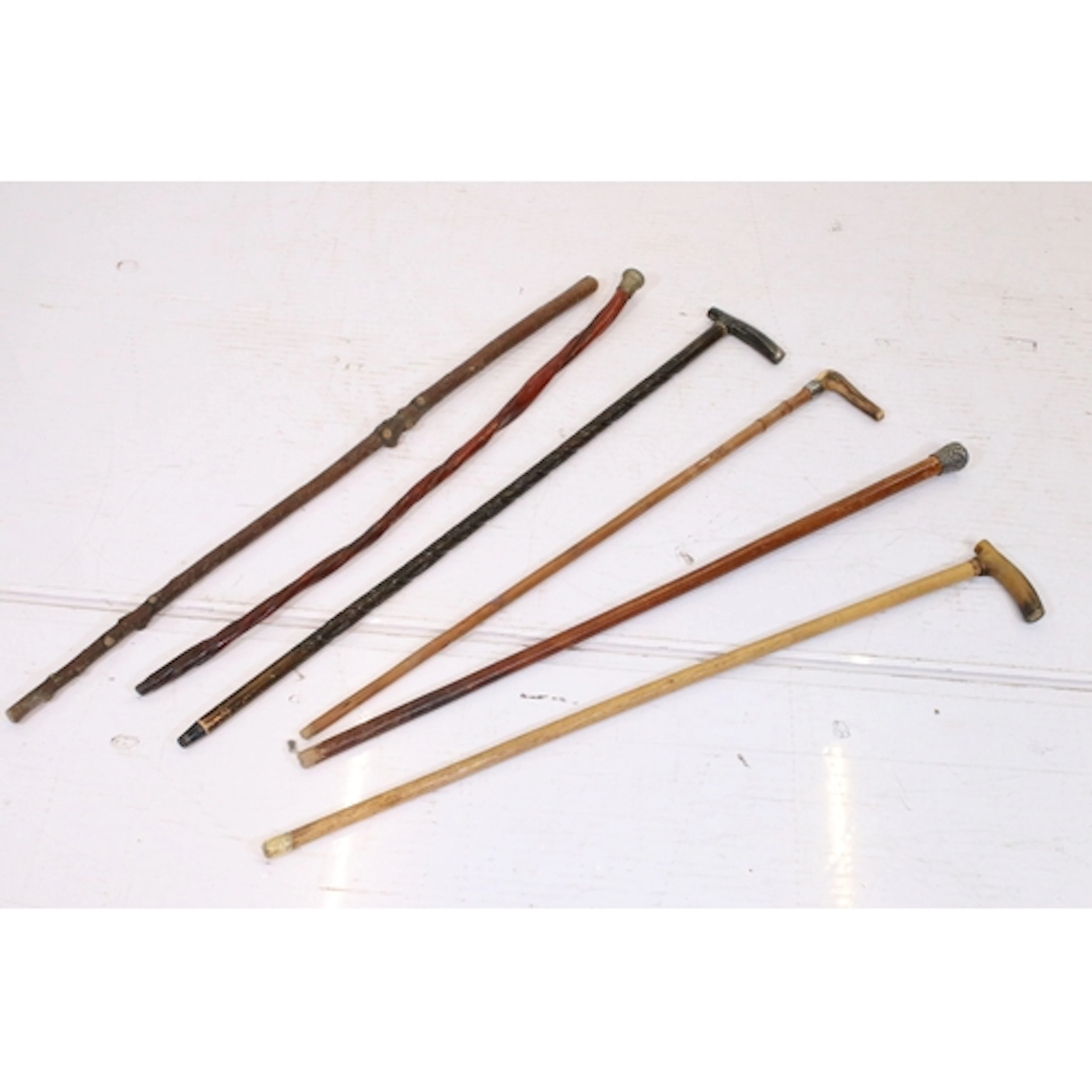 Group of six antique walking sticks, to comprise white metal...