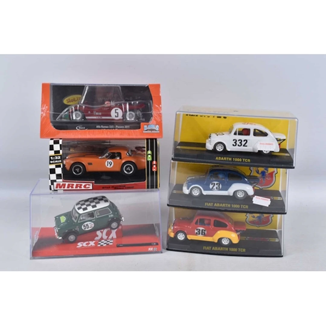 A COLLECTION OF SIX CASED SLOT CARS, to include a Reprotec F...
