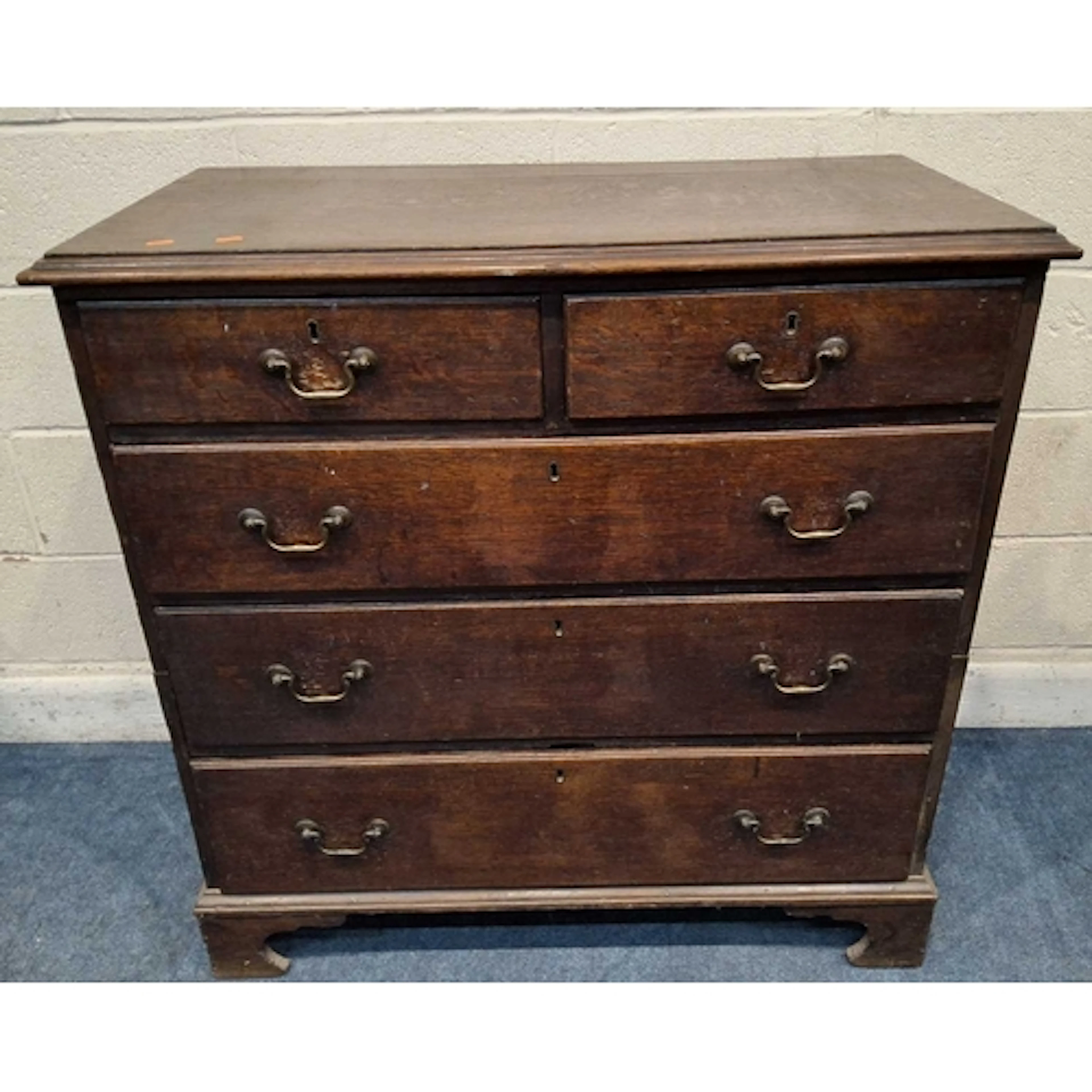 A GEORGIAN OAK CHEST OF TWO SHORT OVER THREE LONG GRADUATED ...