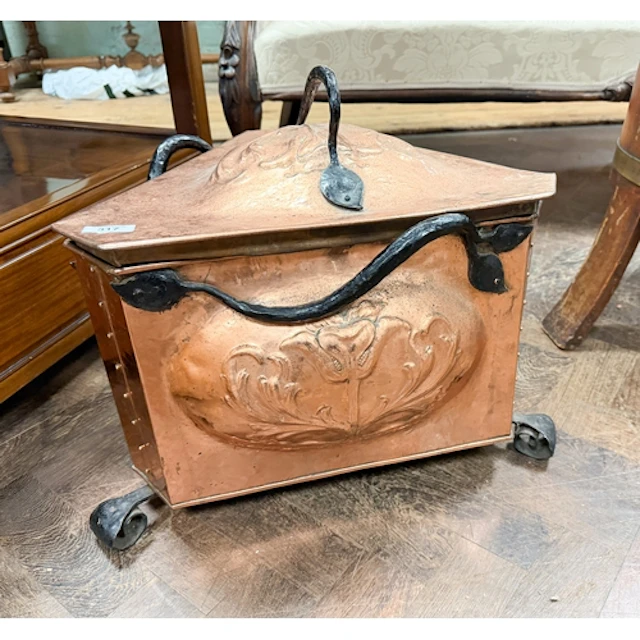 An Art Nouveau triangular copper and iron coal bin