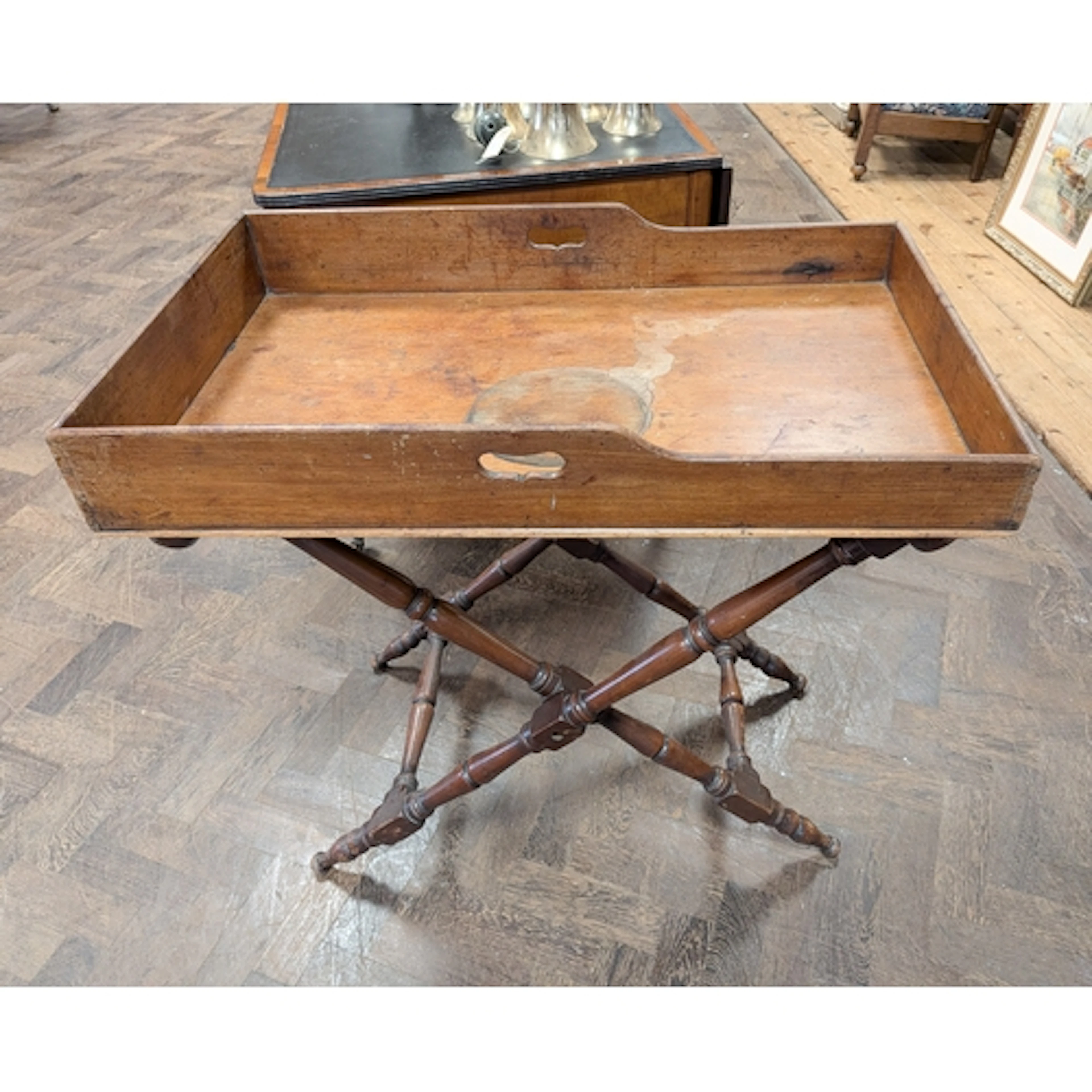 A Victorian country house butlers tray on folding stand, tra...