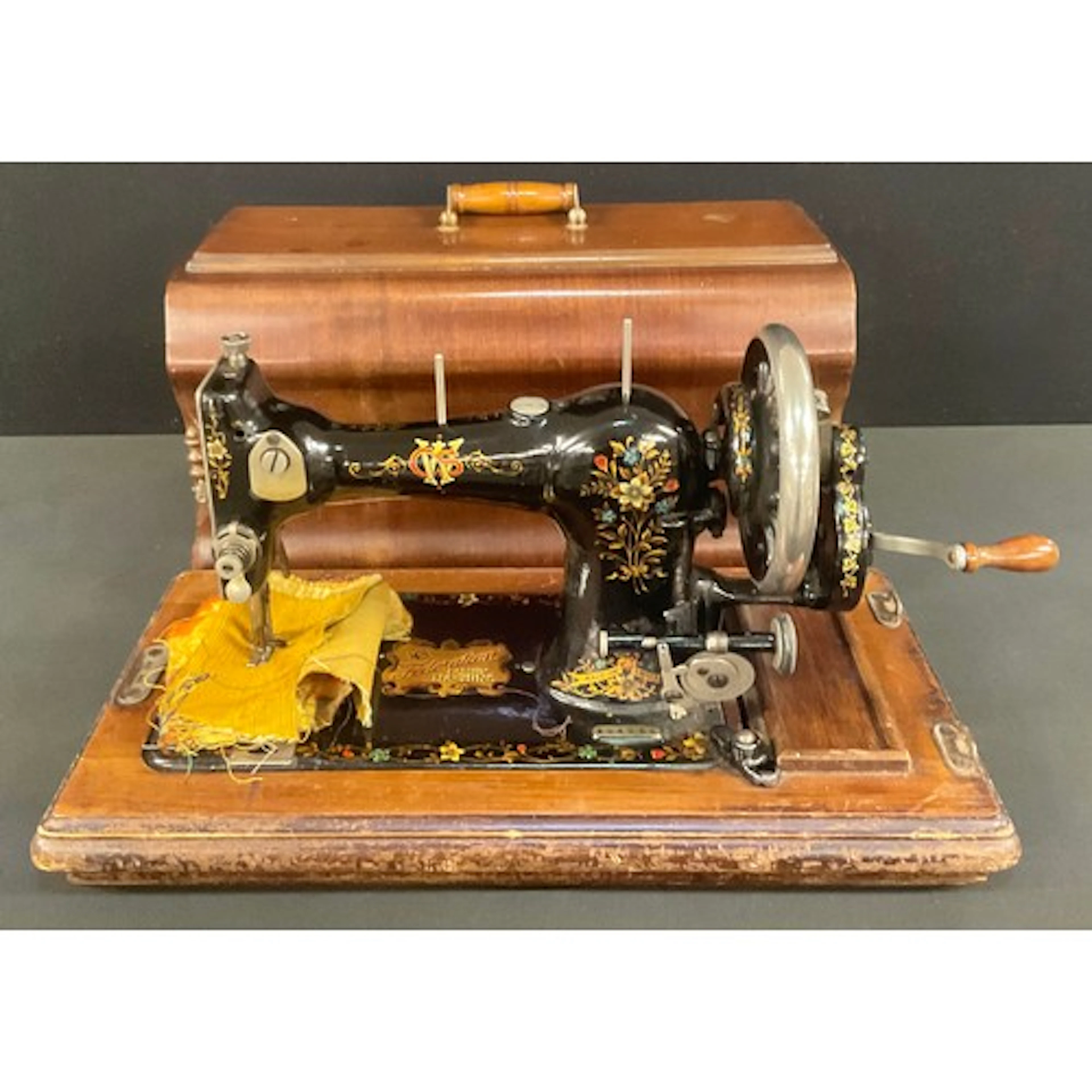 A CWS Federation manual sewing machine, accessories, mahogan...