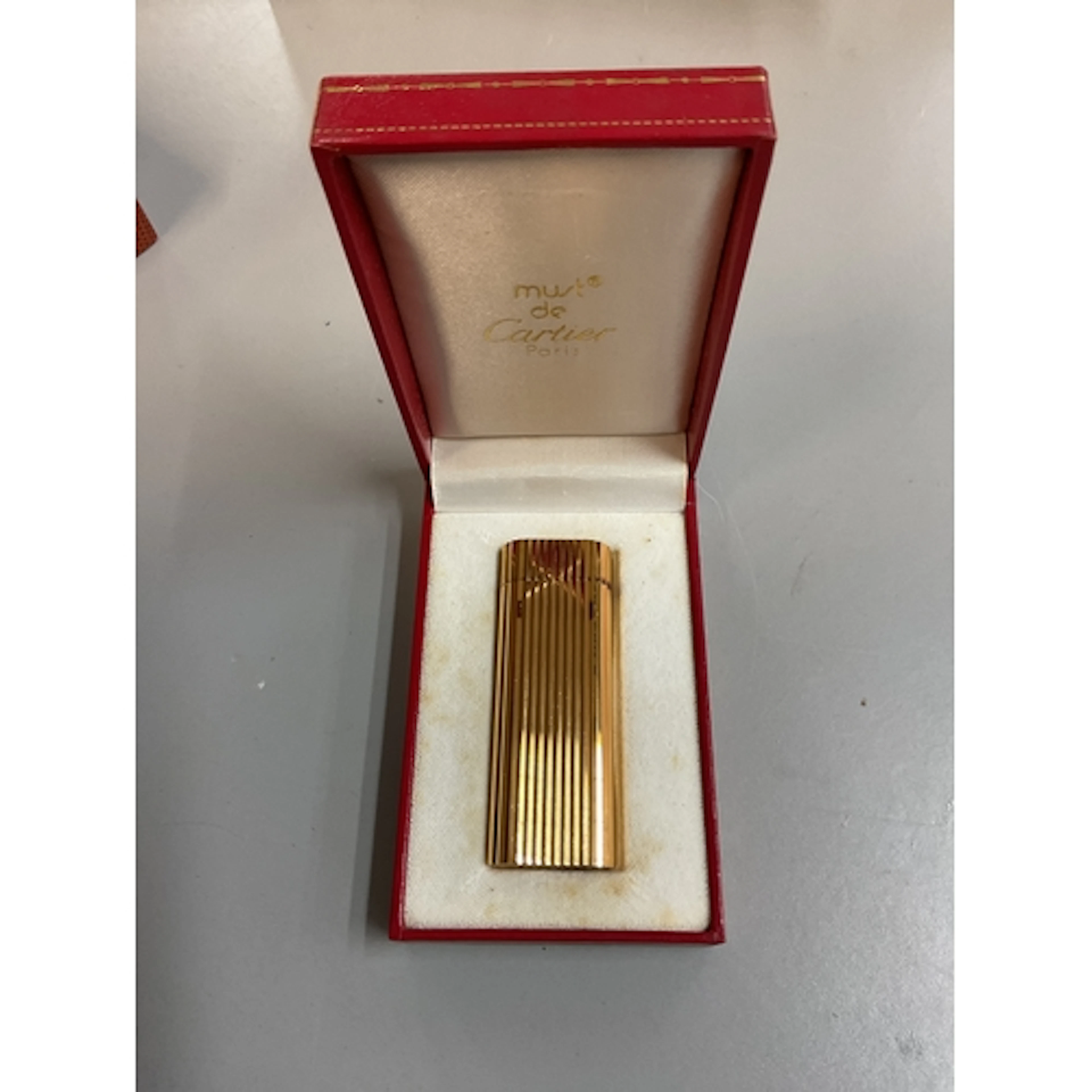 Cased Must de Cartier lighter.