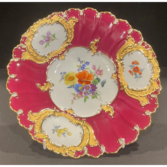 A Meissen shaped circular cabinet plate, decorated with colo...
