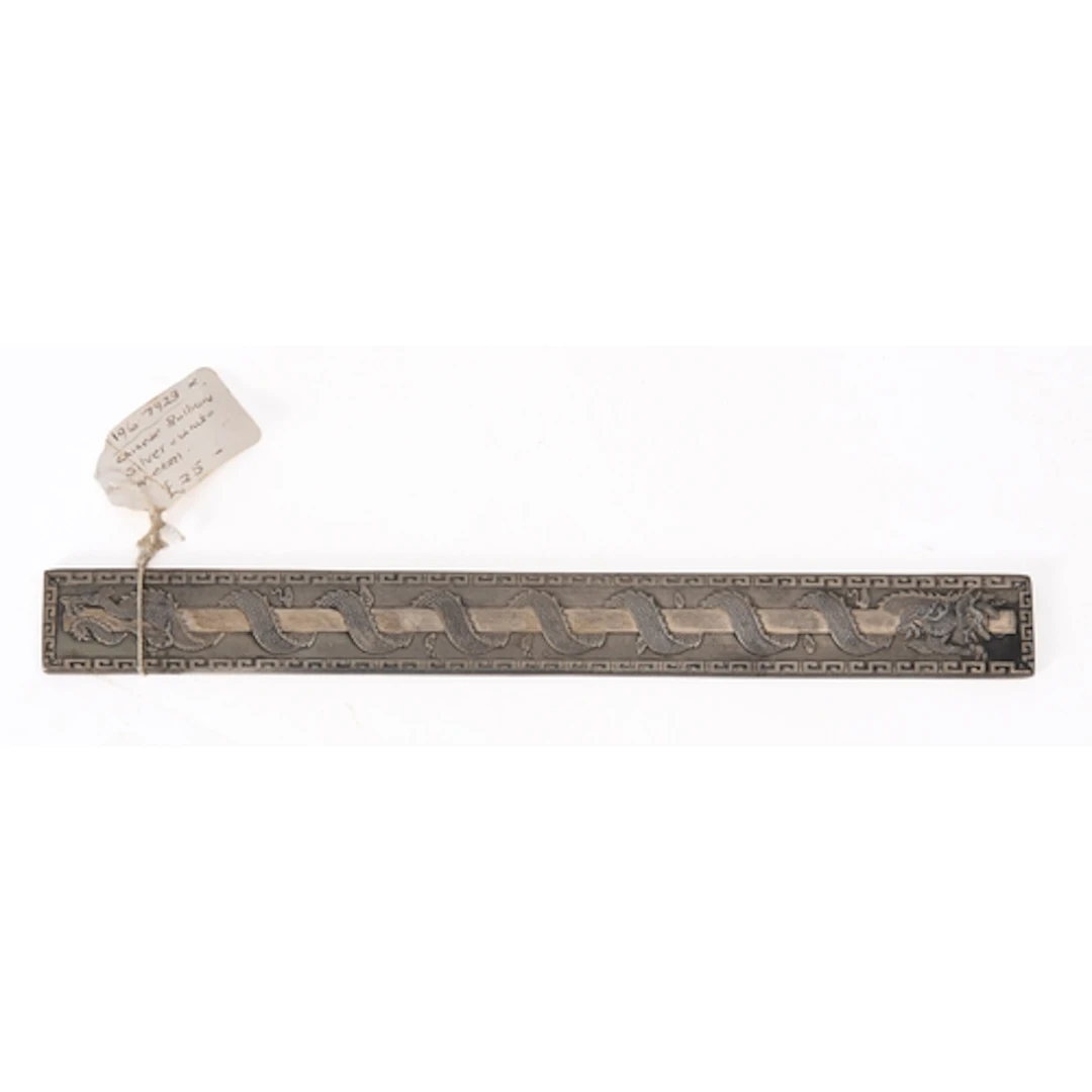 A Chinese white metal paperweight or scroll weight, with a d...