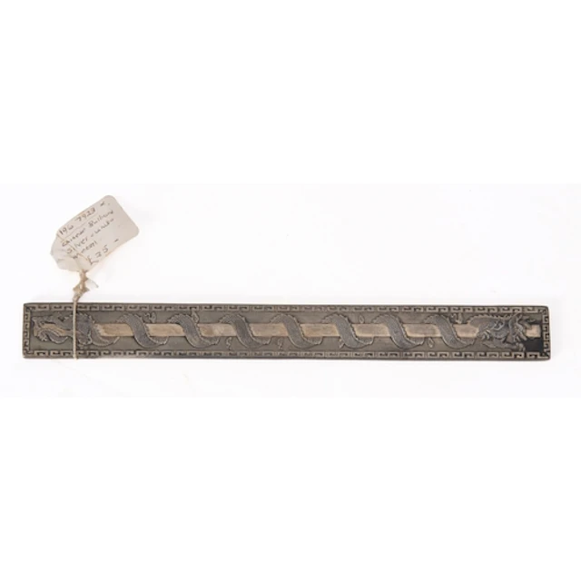 A Chinese white metal paperweight or scroll weight, with a d...