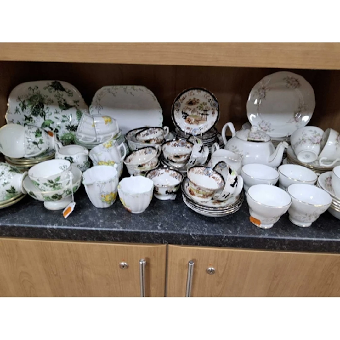 A GROUP OF FOUR VINTAGE CERAMIC TEA SETS comprising a Coalpo...