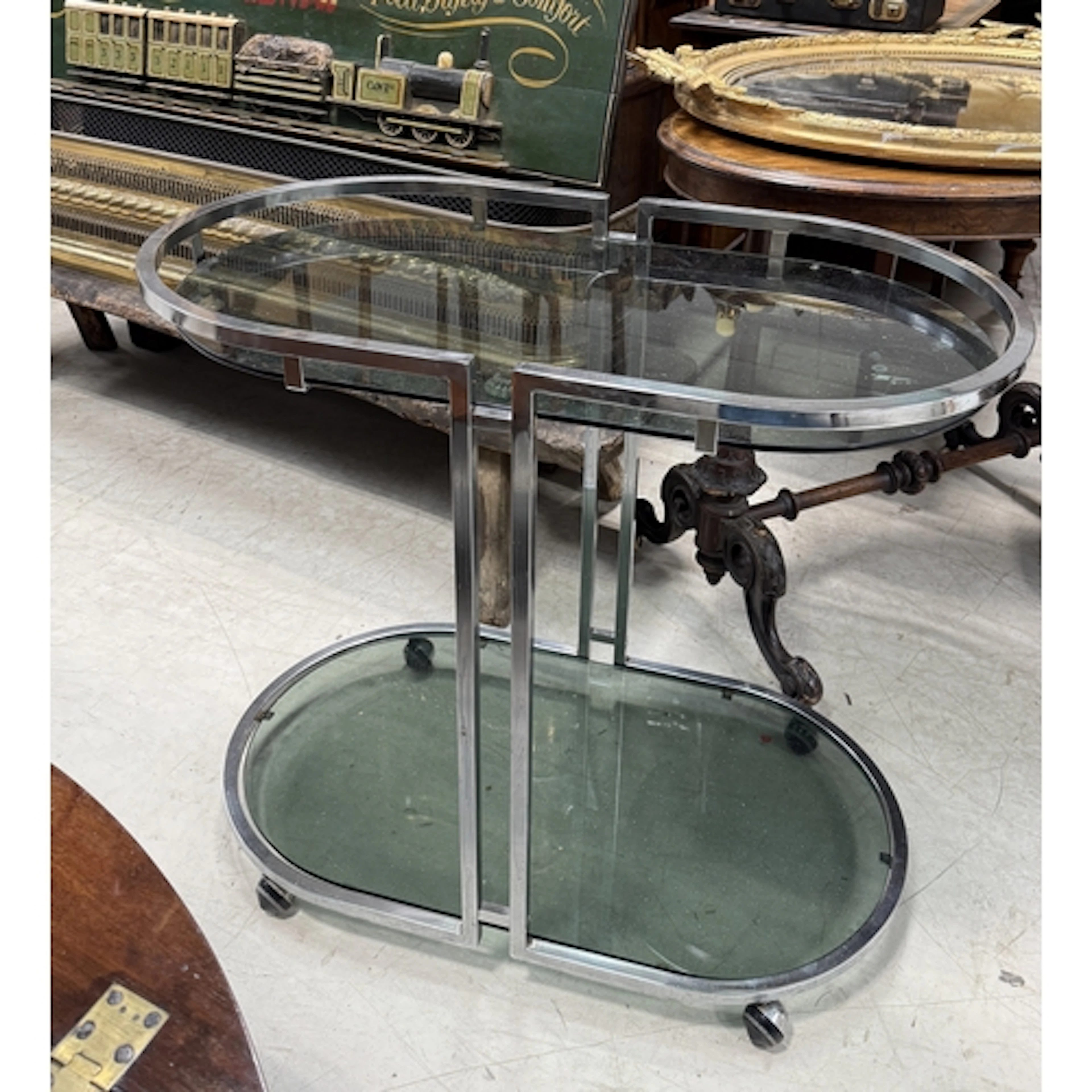A MID-CENTURY CHROME AND SMOKED GLASS TWO-TIER DRINKS TROLLE...