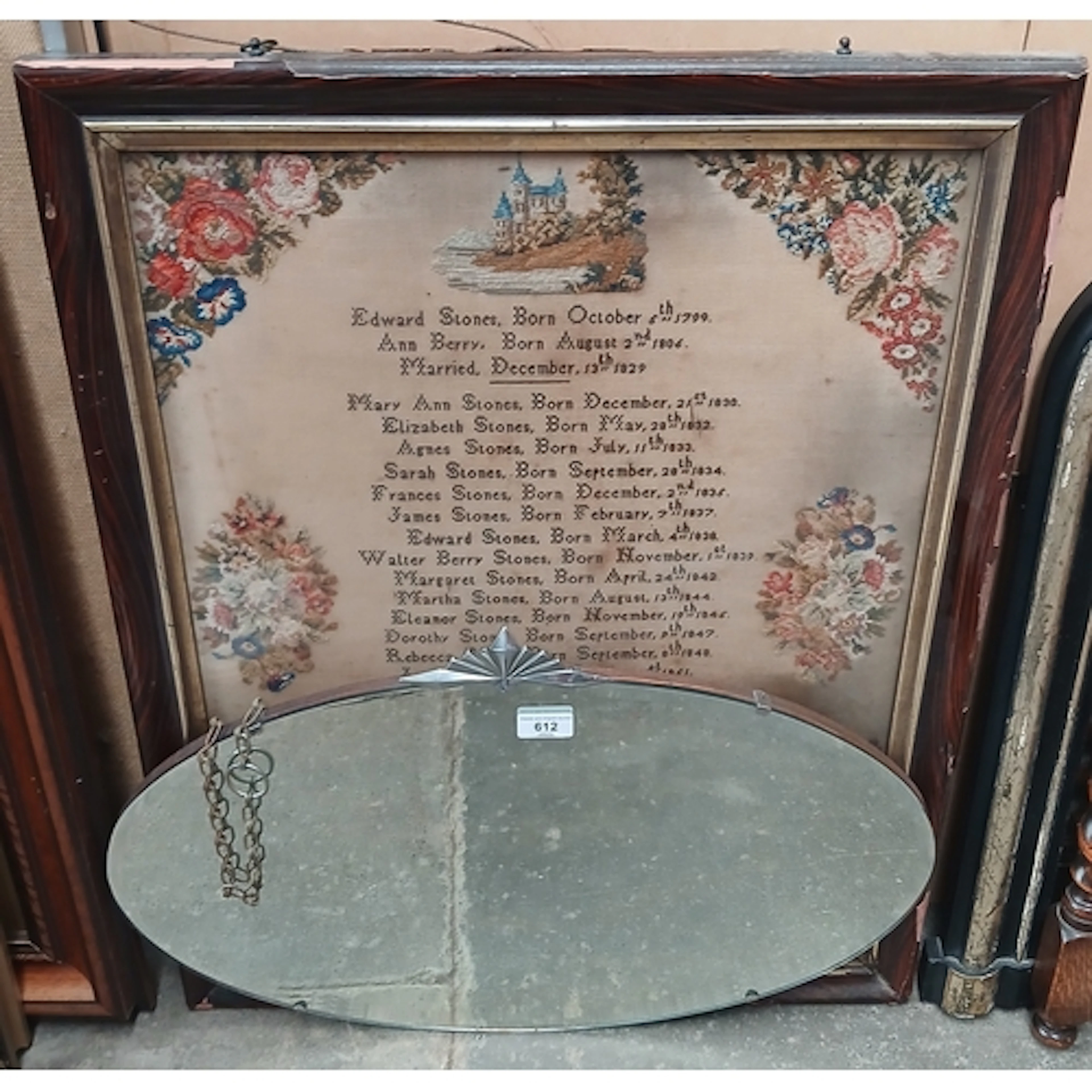 A 19th century sampler and an Art Deco mirror.