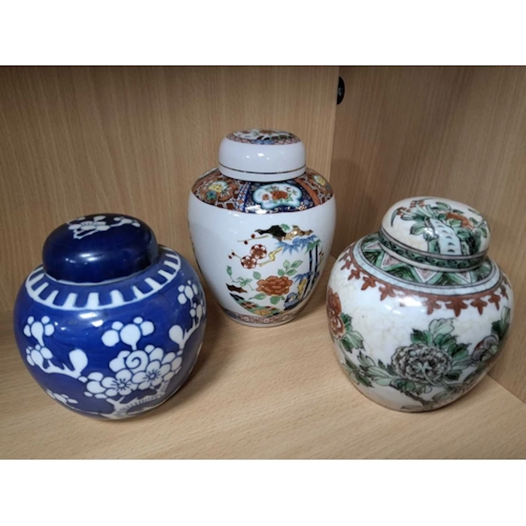 THREE ORIENTAL GINGER JARS AND COVERS, one blue and white wi...