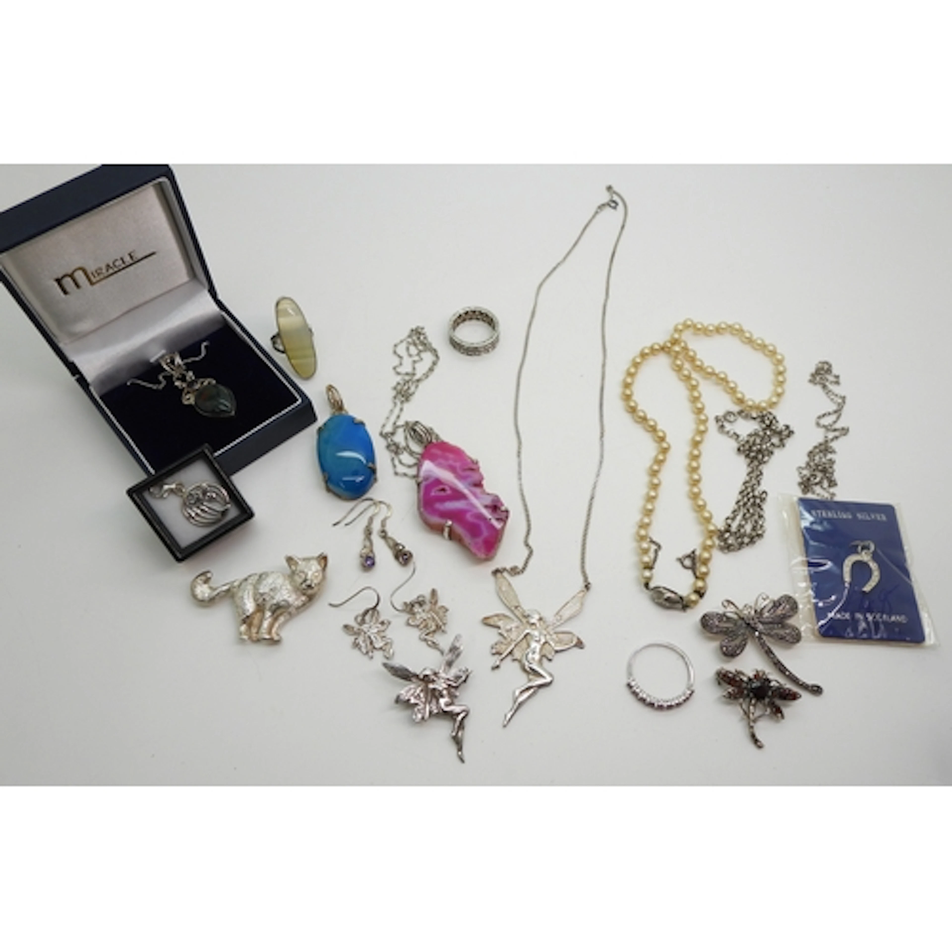 A silver fairy;- necklace, earrings and brooch, garnet set d...