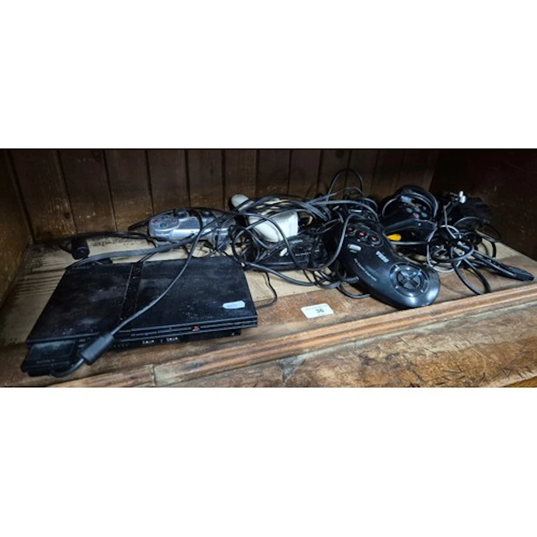 A Sony PS2 console and various game controllers