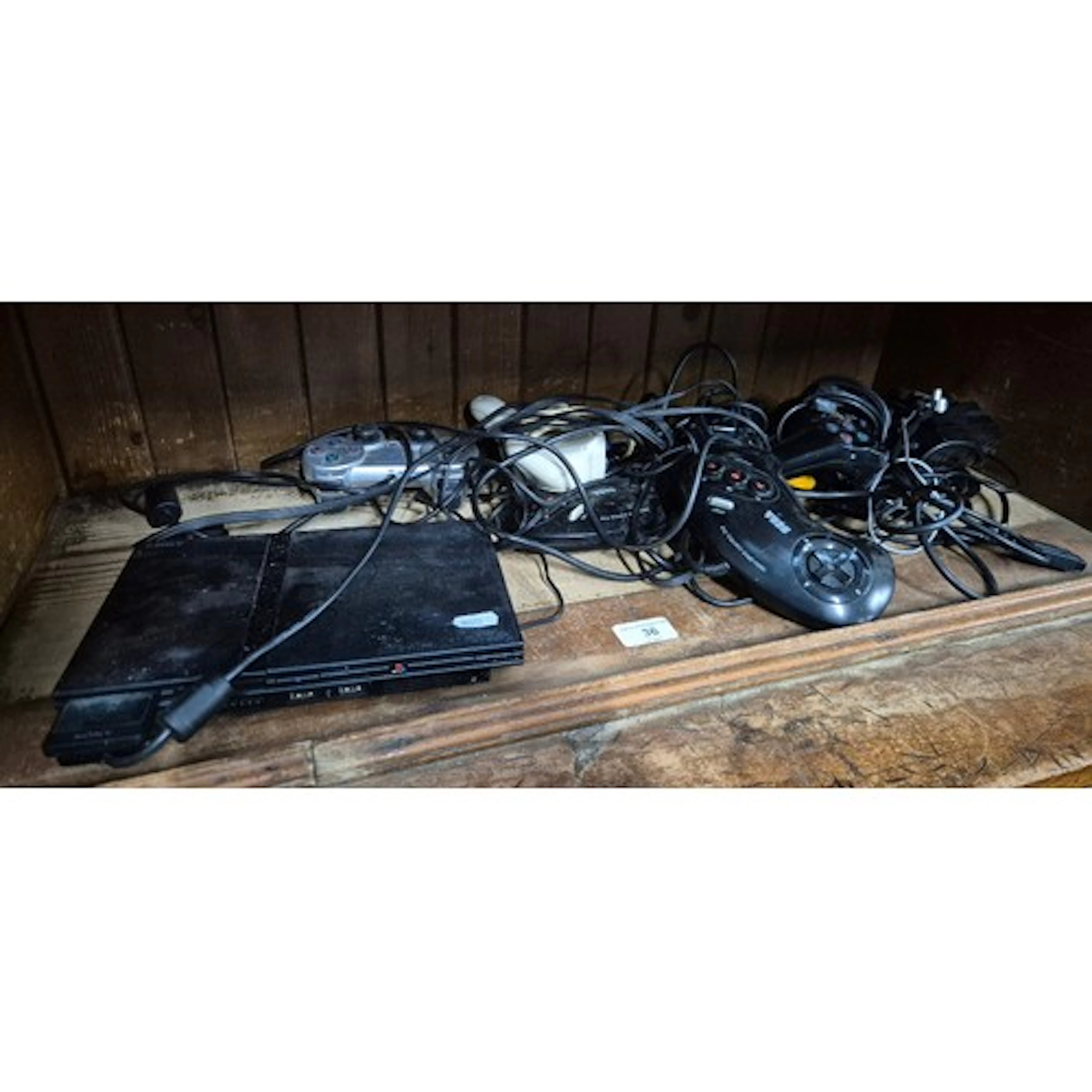 A Sony PS2 console and various game controllers
