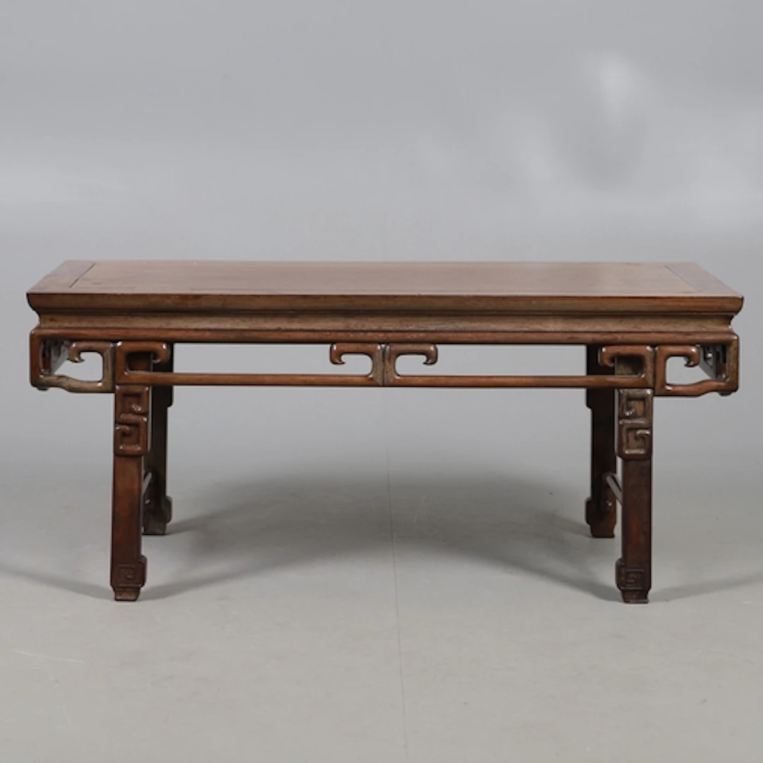 A CHINESE HUANGHUALI LOW COFFEE TABLE. the rectangular top u...