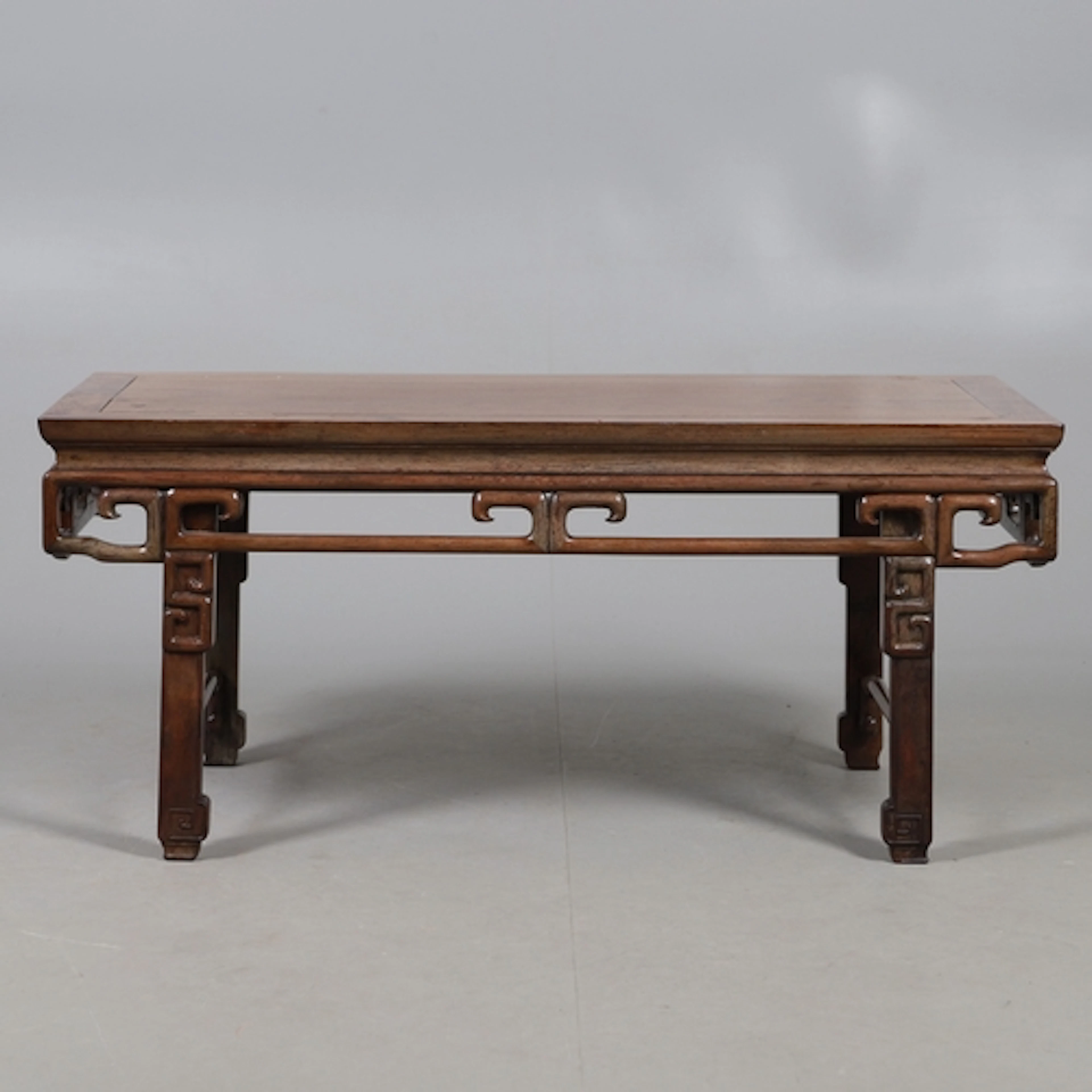 A CHINESE HUANGHUALI LOW COFFEE TABLE. the rectangular top u...