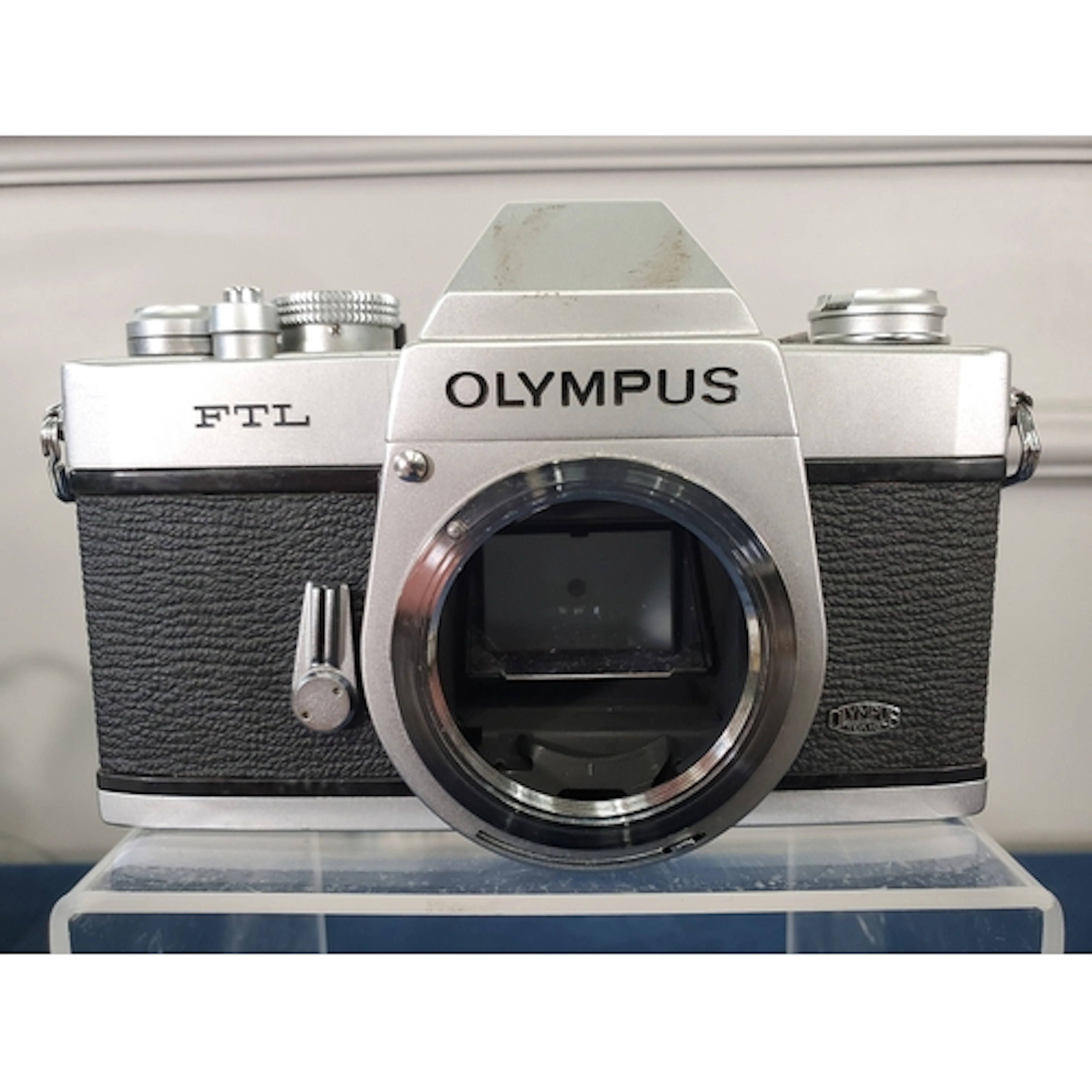 An Olympus FTL with 50mm f1.8 and case, (lens front dented),...