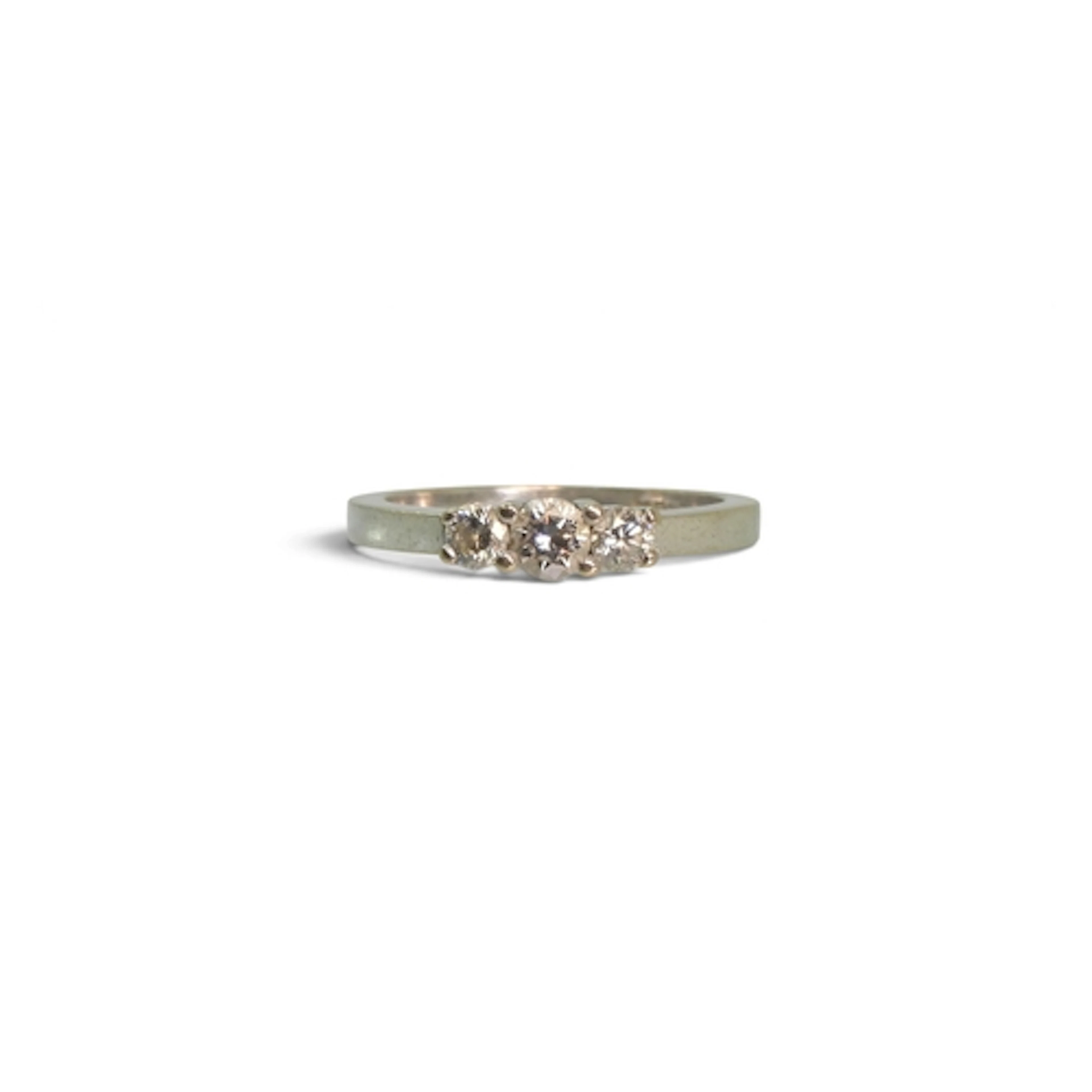 An 18ct white gold three stone diamond ring, set with estima...