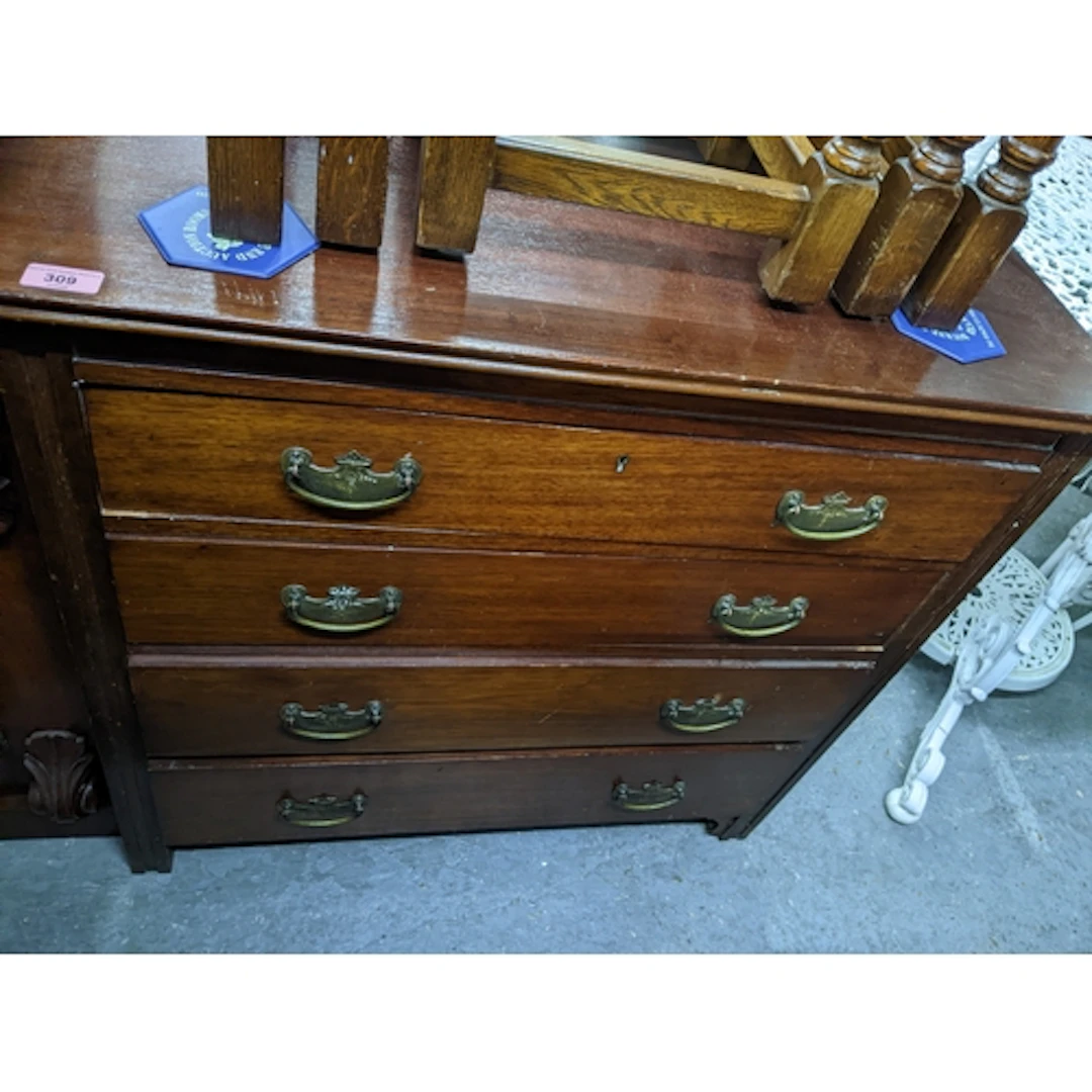 A mahogany four drawer chest of drawers with brass handles, ...