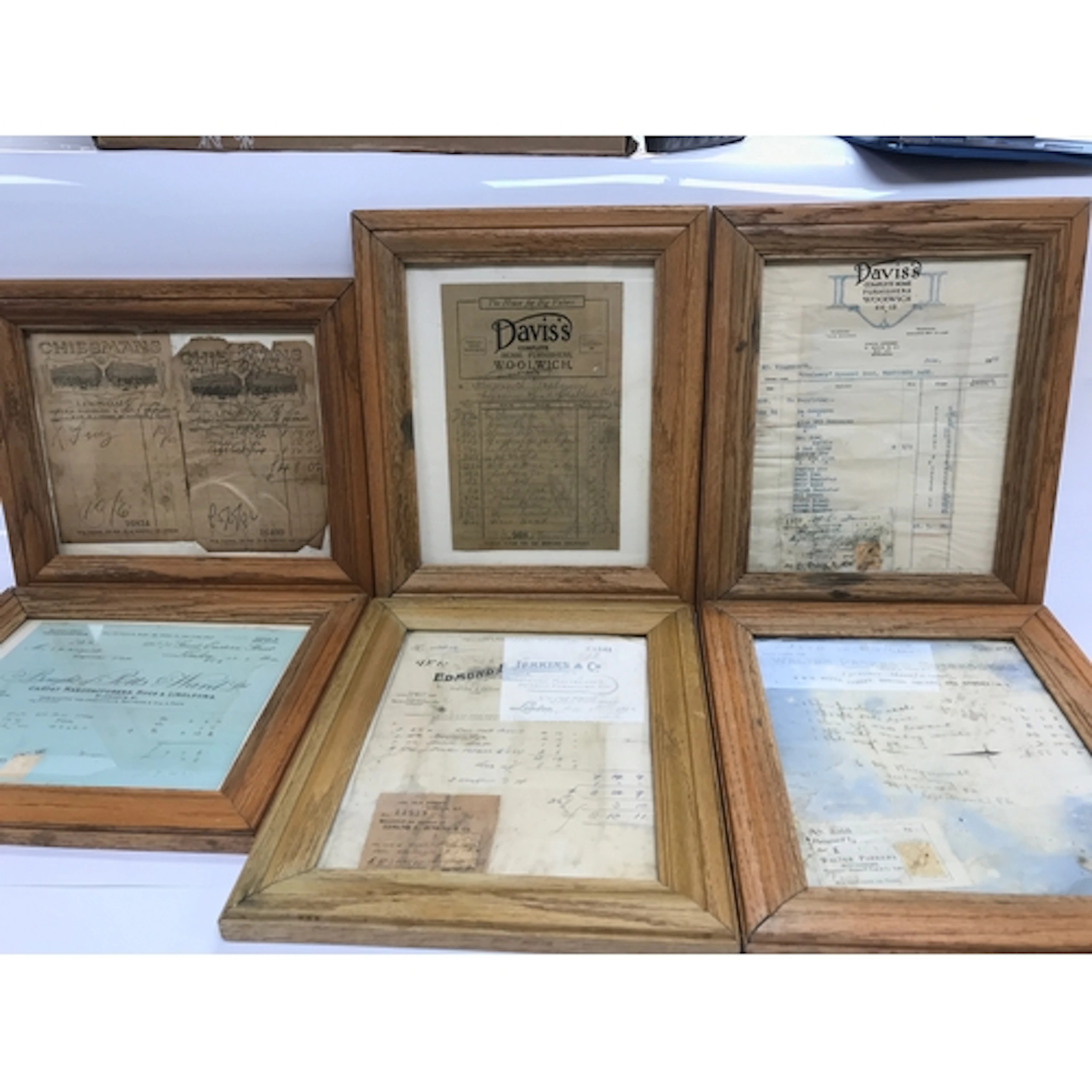 Antique framed paper ephemera items, including old tradesmen...
