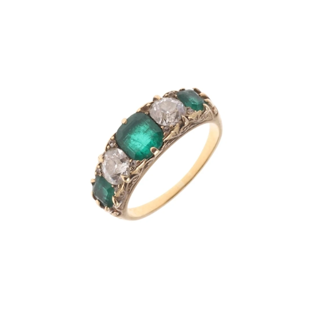 AN EMERALD AND DIAMOND FIVE STONE RING. the three rectangula...