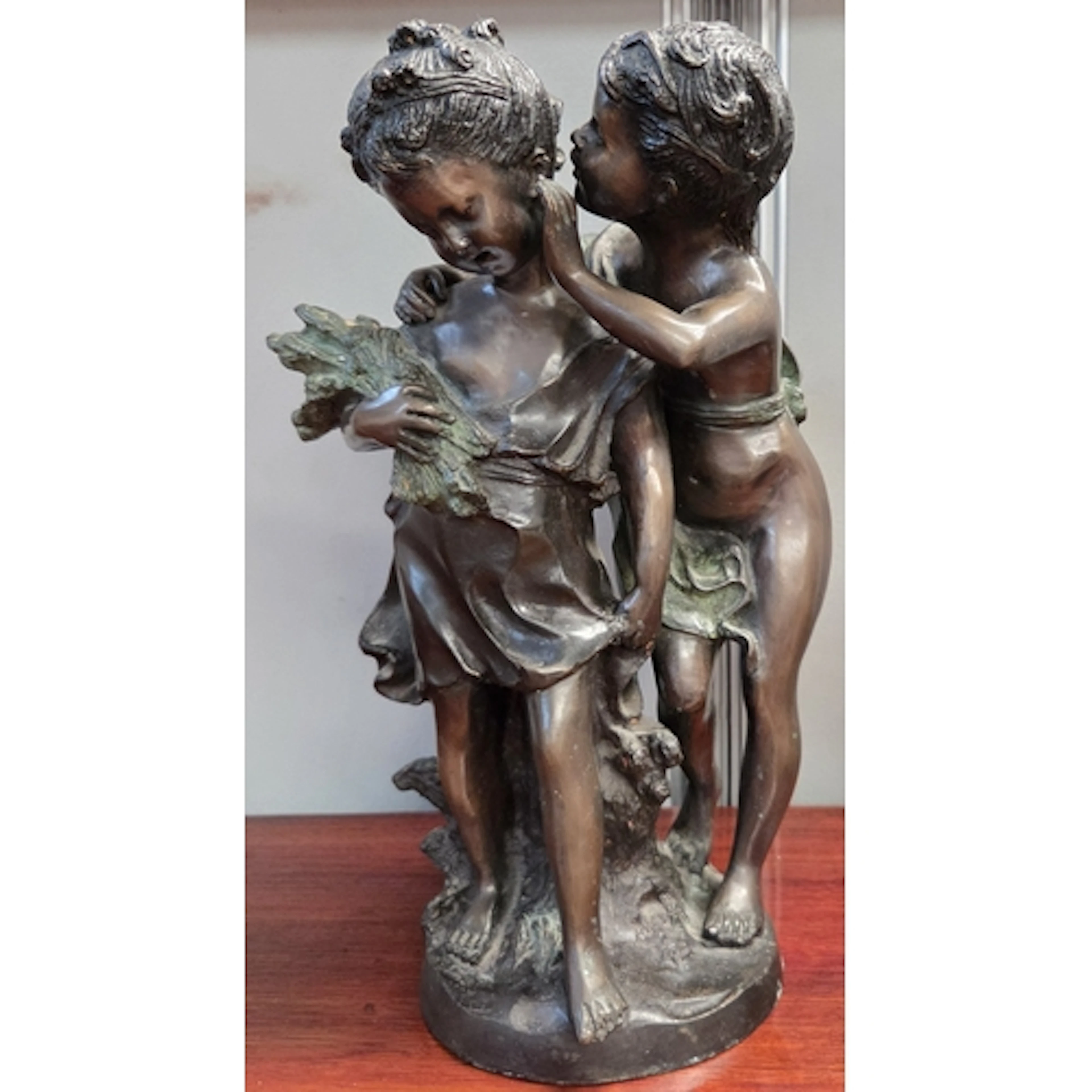 A bronze figural sculpture after Auguste Moreau "Un Secret" ...