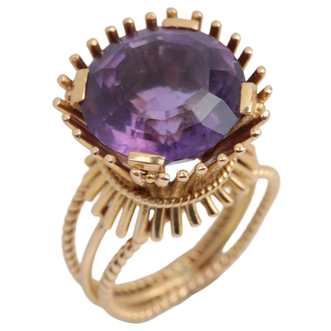 An amethyst and gold cocktail ring, mid 20th century, set wi...