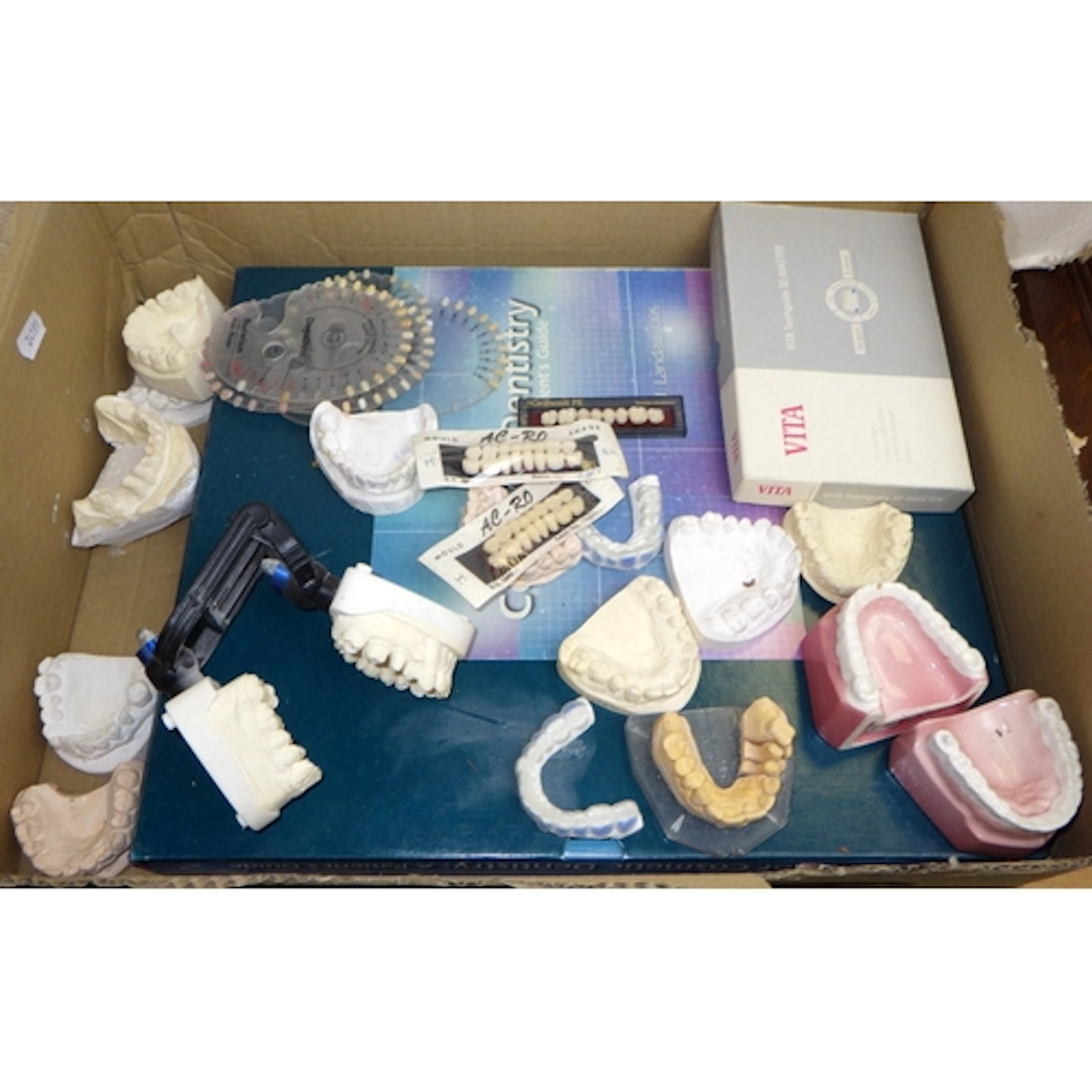 An Atlas Of Cosmetic Dentistry book together with a group of...