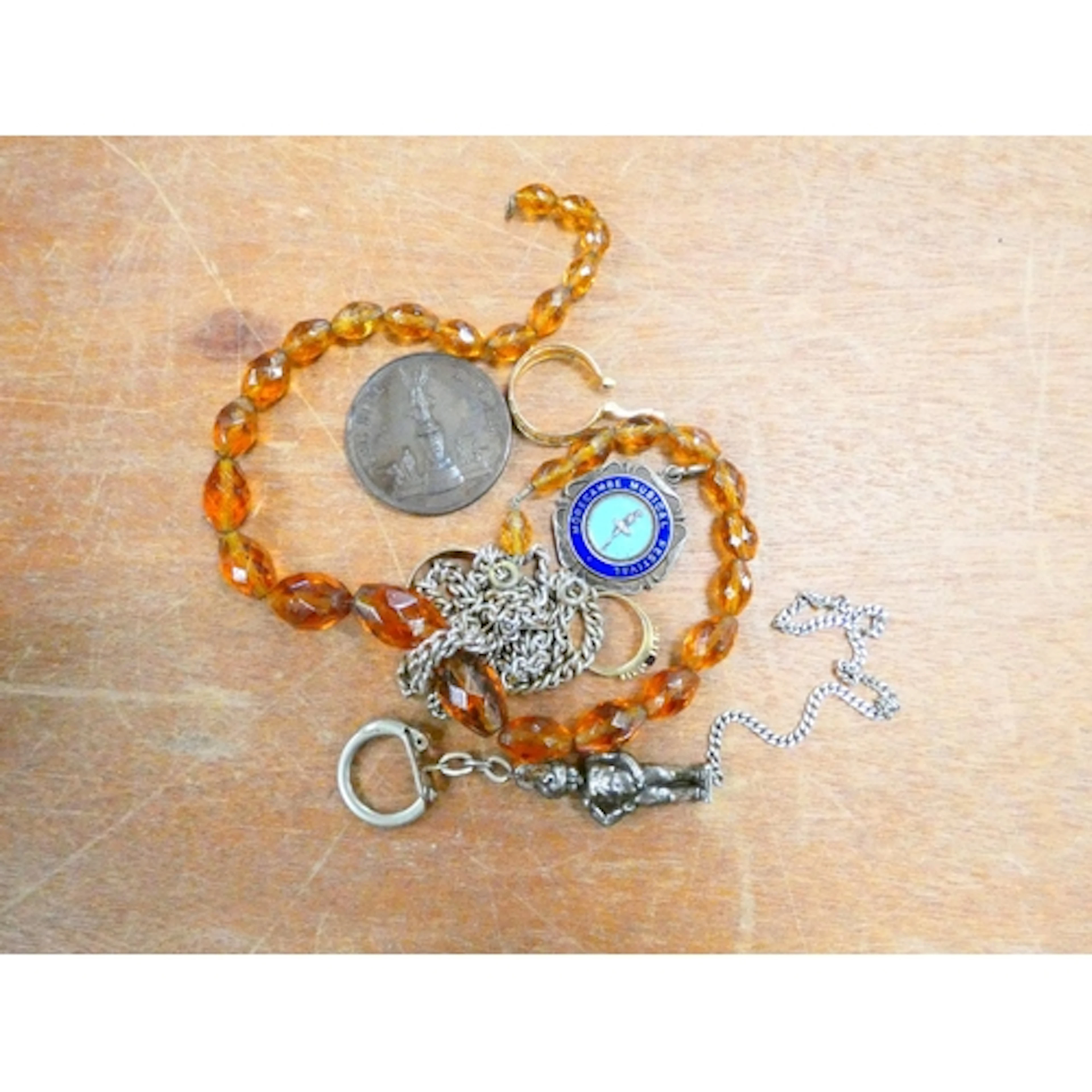 A bag of costume jewellery to include simulated amber neckla...