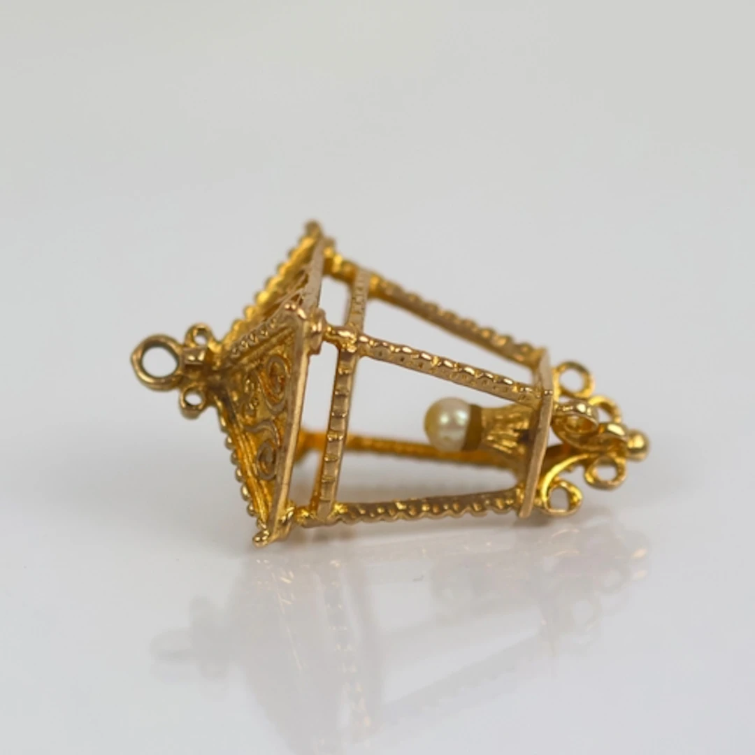 A late 20th century yellow metal charm, modelled as a lanter...