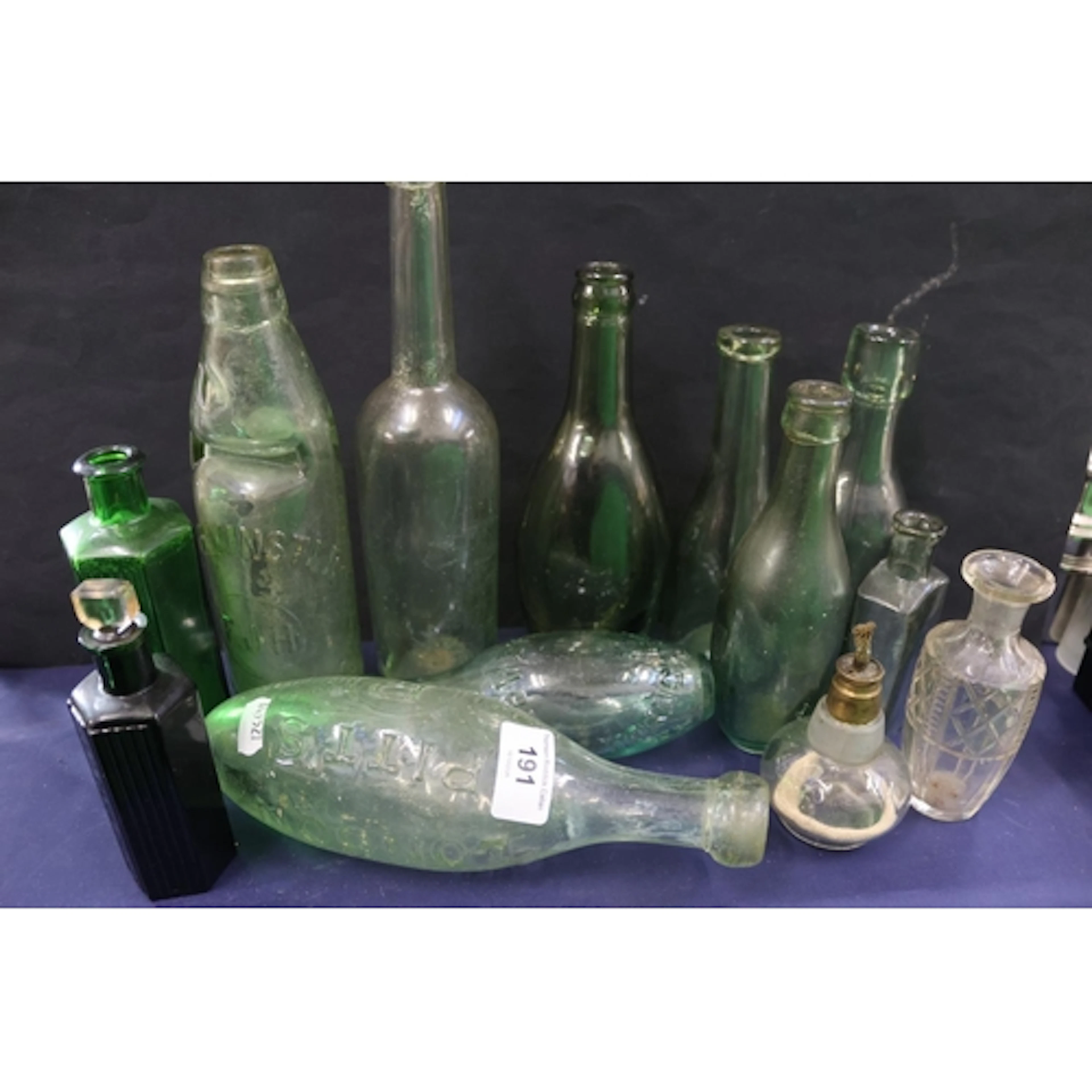 Vintage glass bottles including Pitts of London and T Levett...