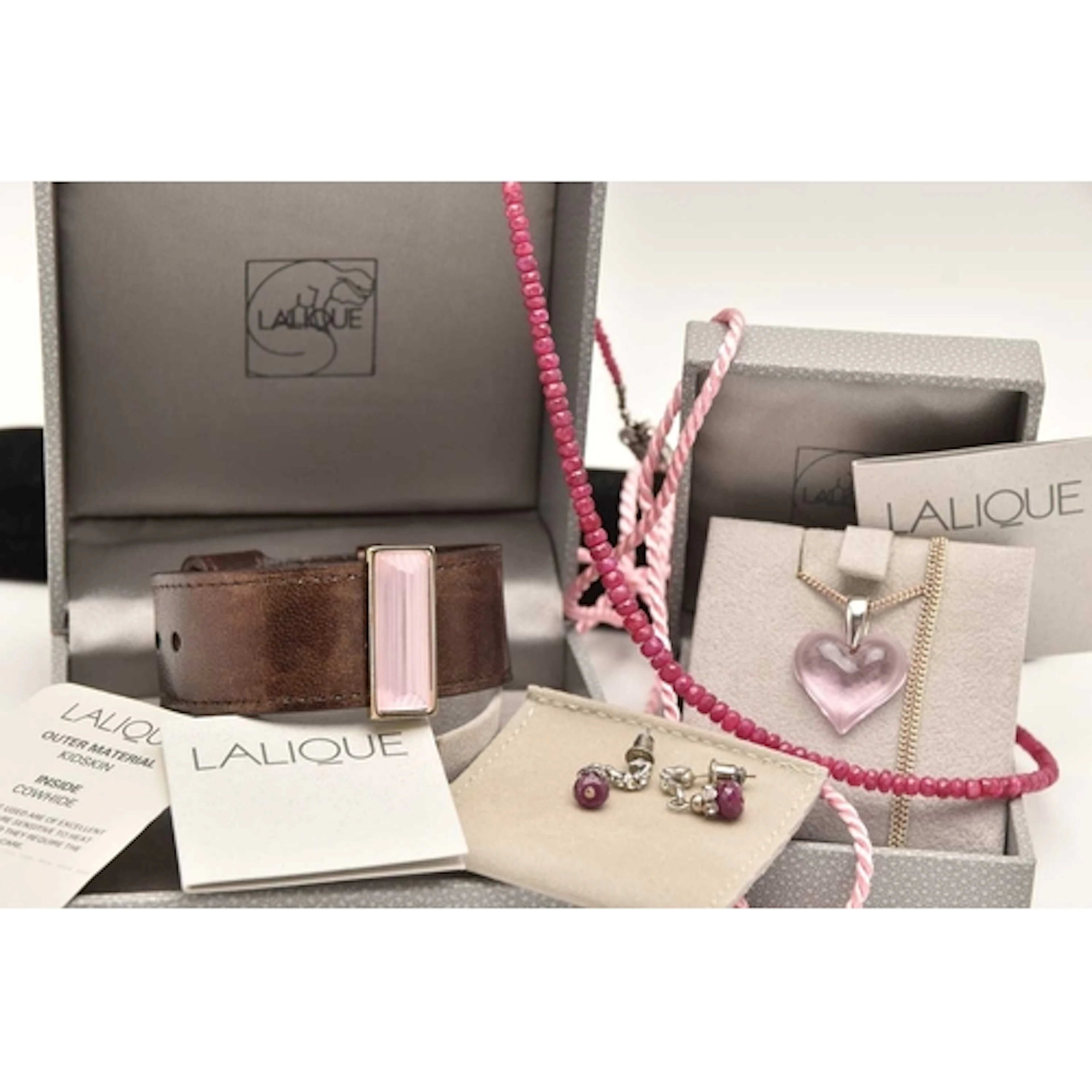 FOUR ITEMS OF JEWELLERY, to include a boxed 'Lalique' pink h...