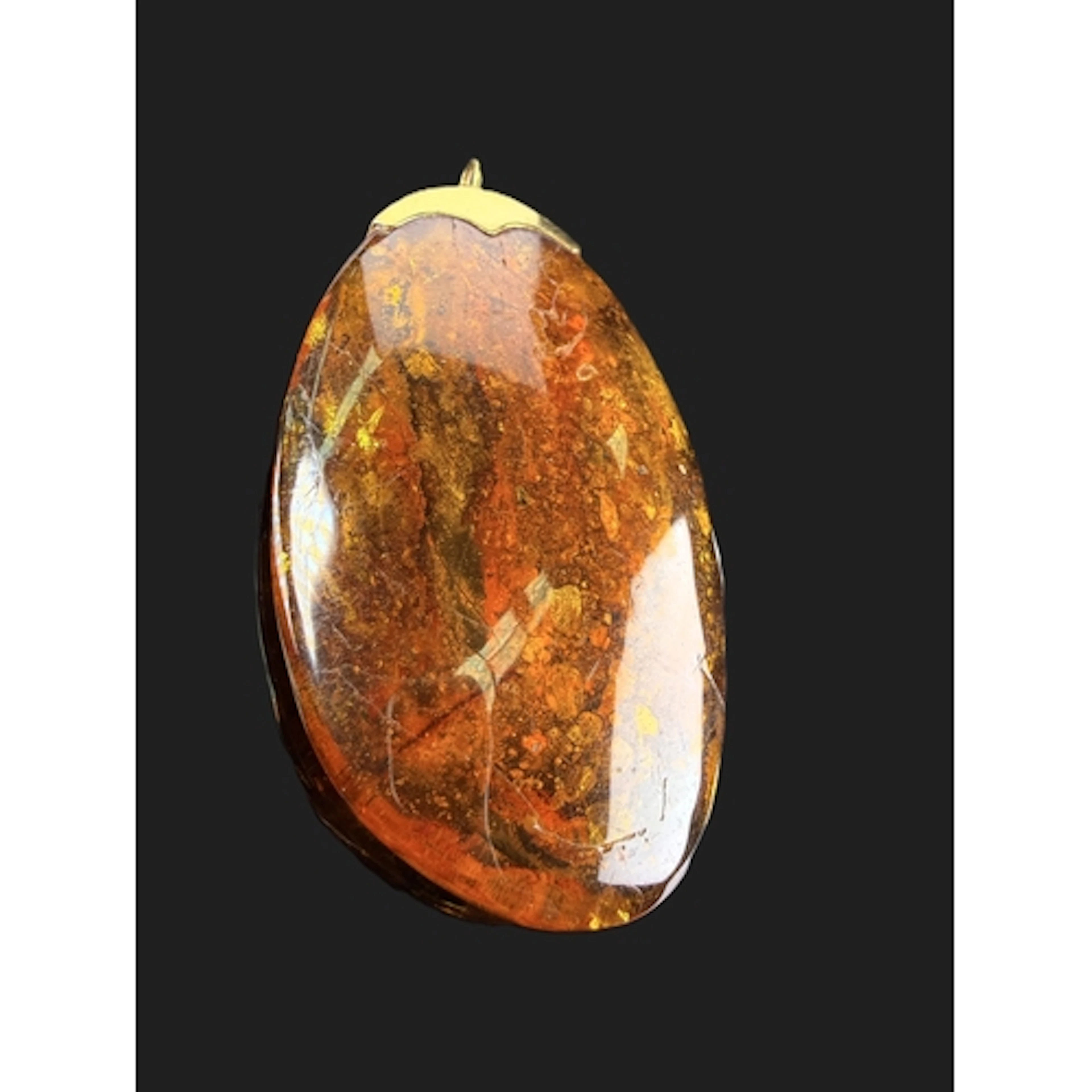 A mid 20th century Amber pendant with 18ct gold hall marked ...