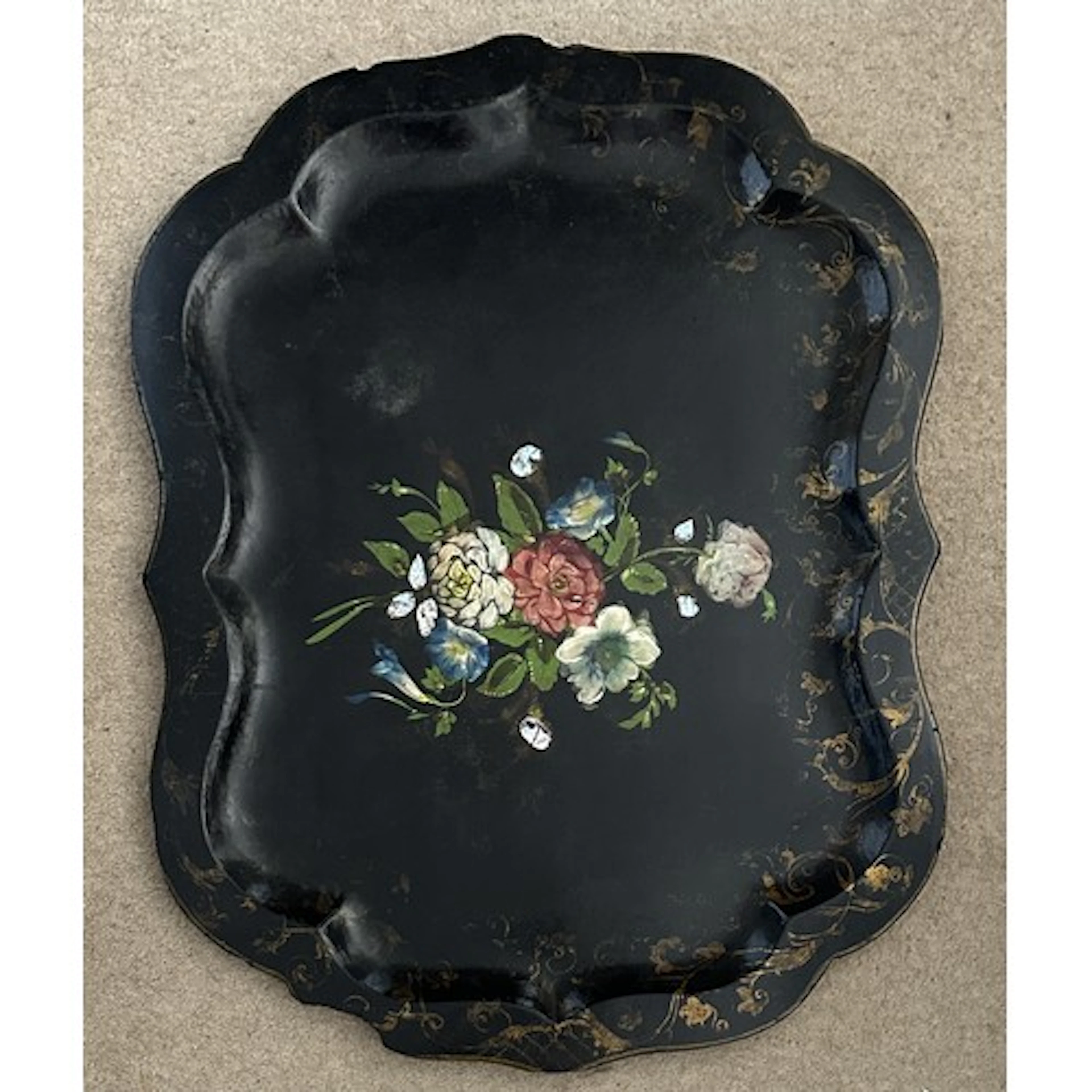 A Victorian papier-mâché tray with a black lacquered finish,...