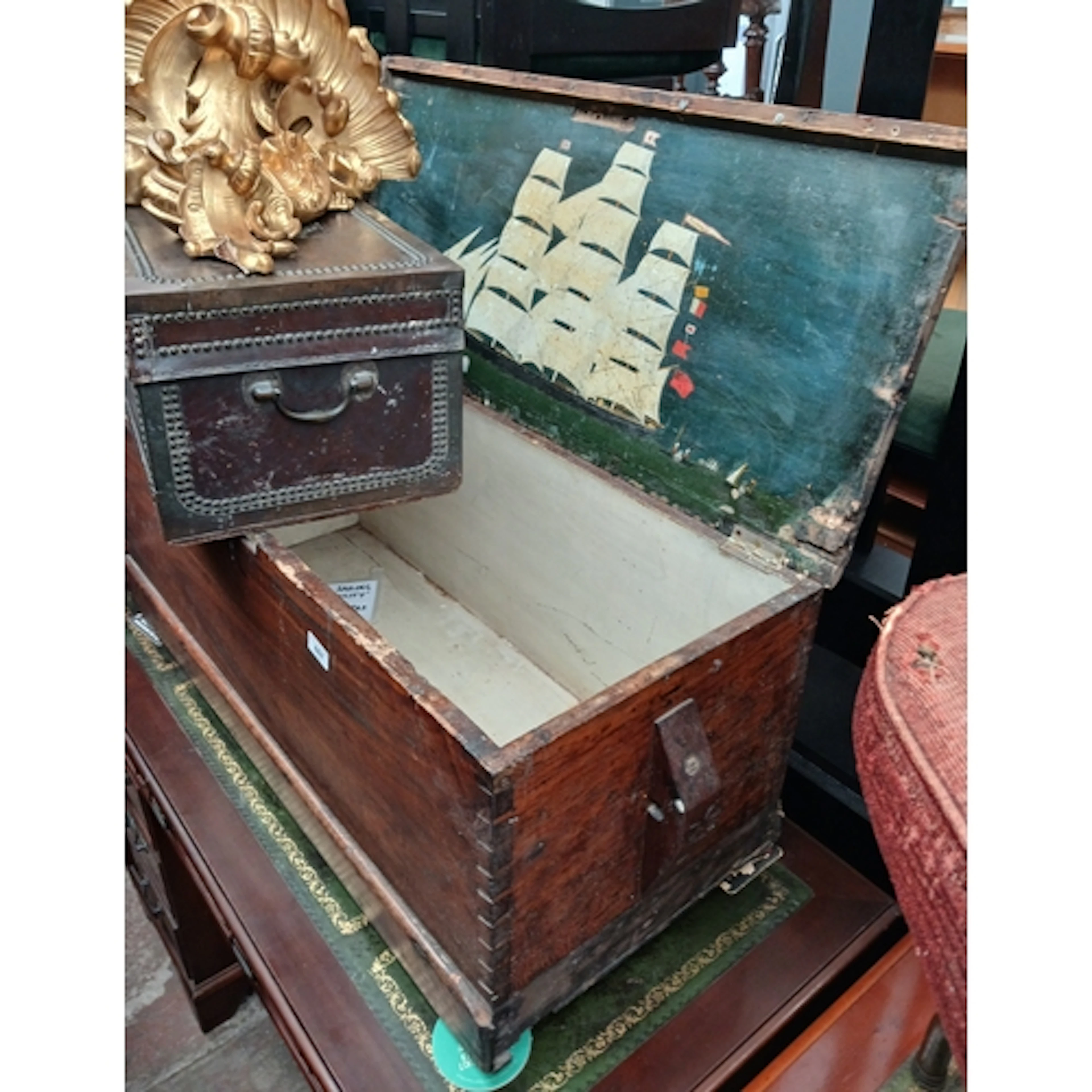 A camphor wood chest, the interior lid painted with a three ...