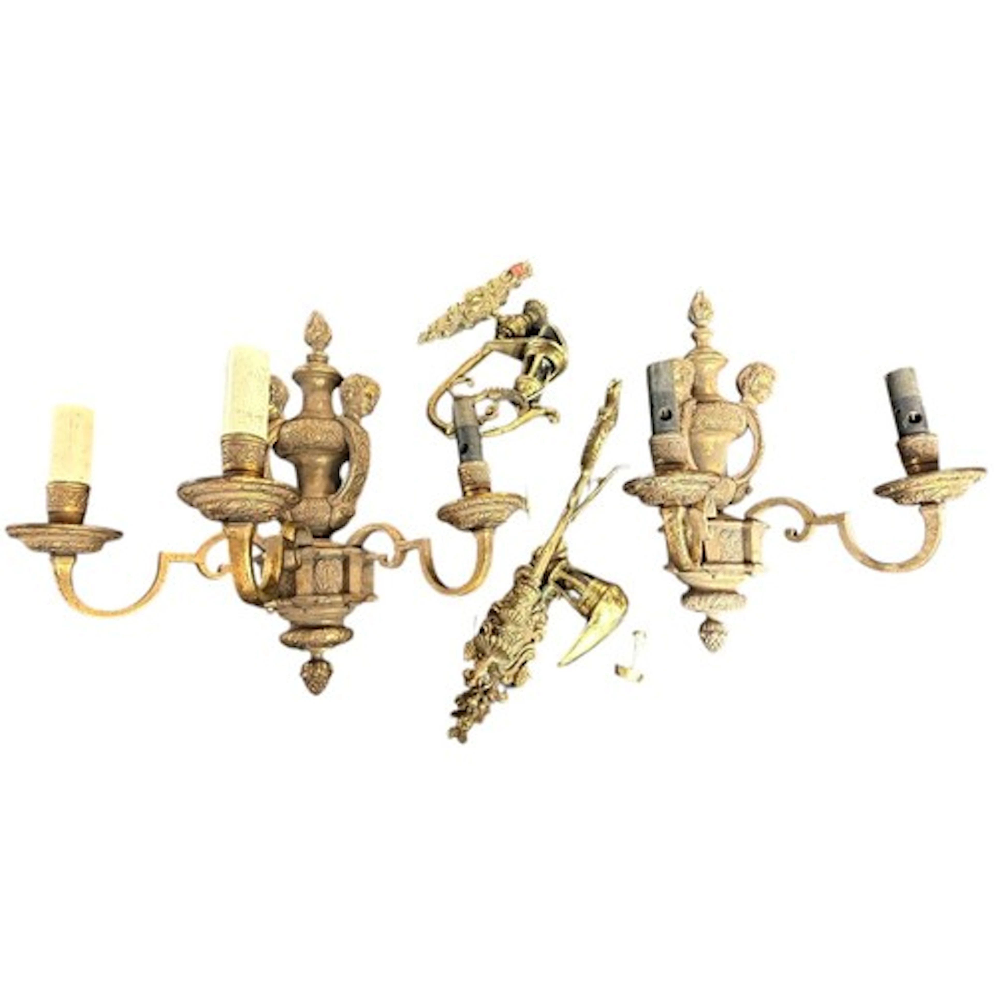A pair of Louis XVI style brass three sconce wall lights tog...