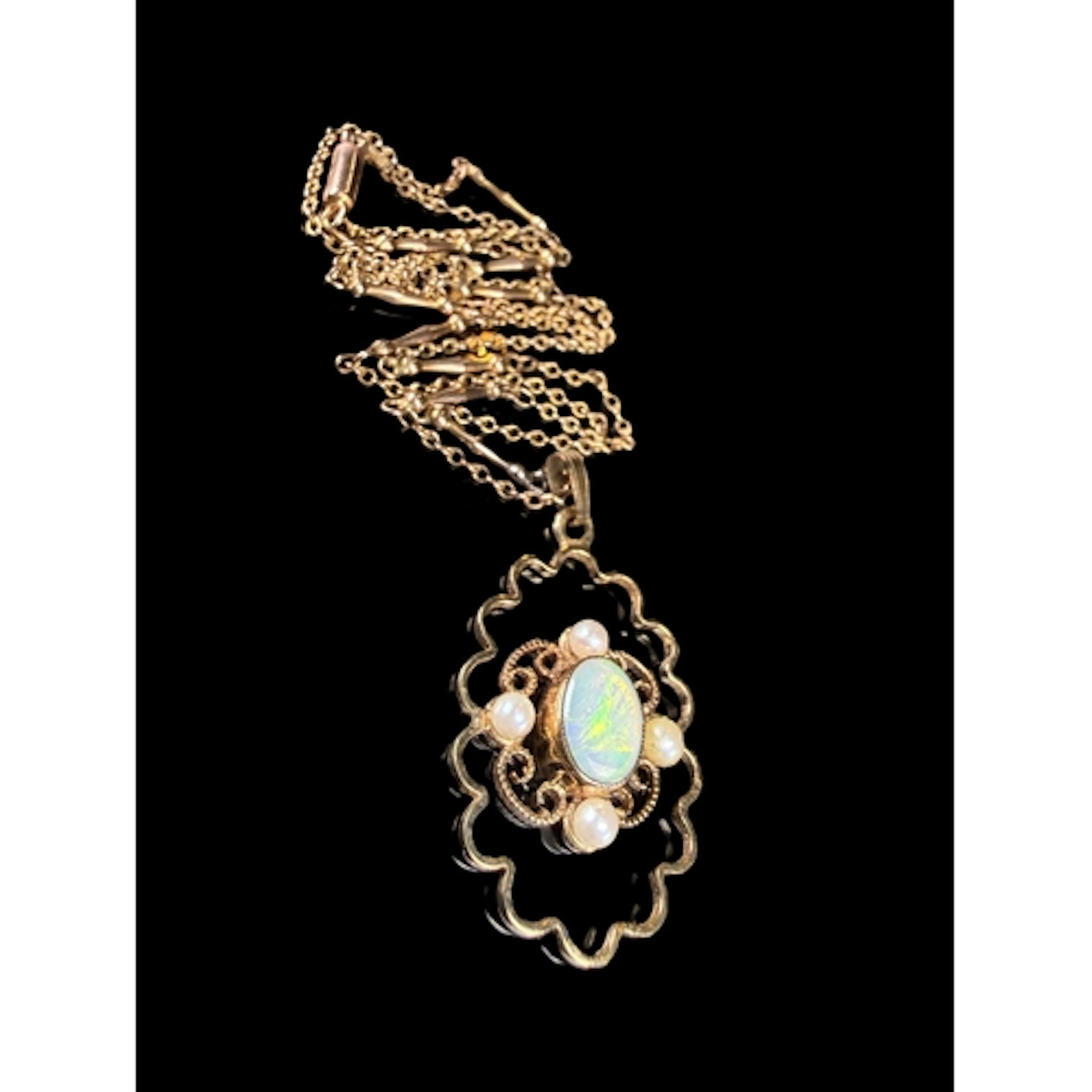 A yellow metal pendant set with opal and pearls, on 9 ct gol...