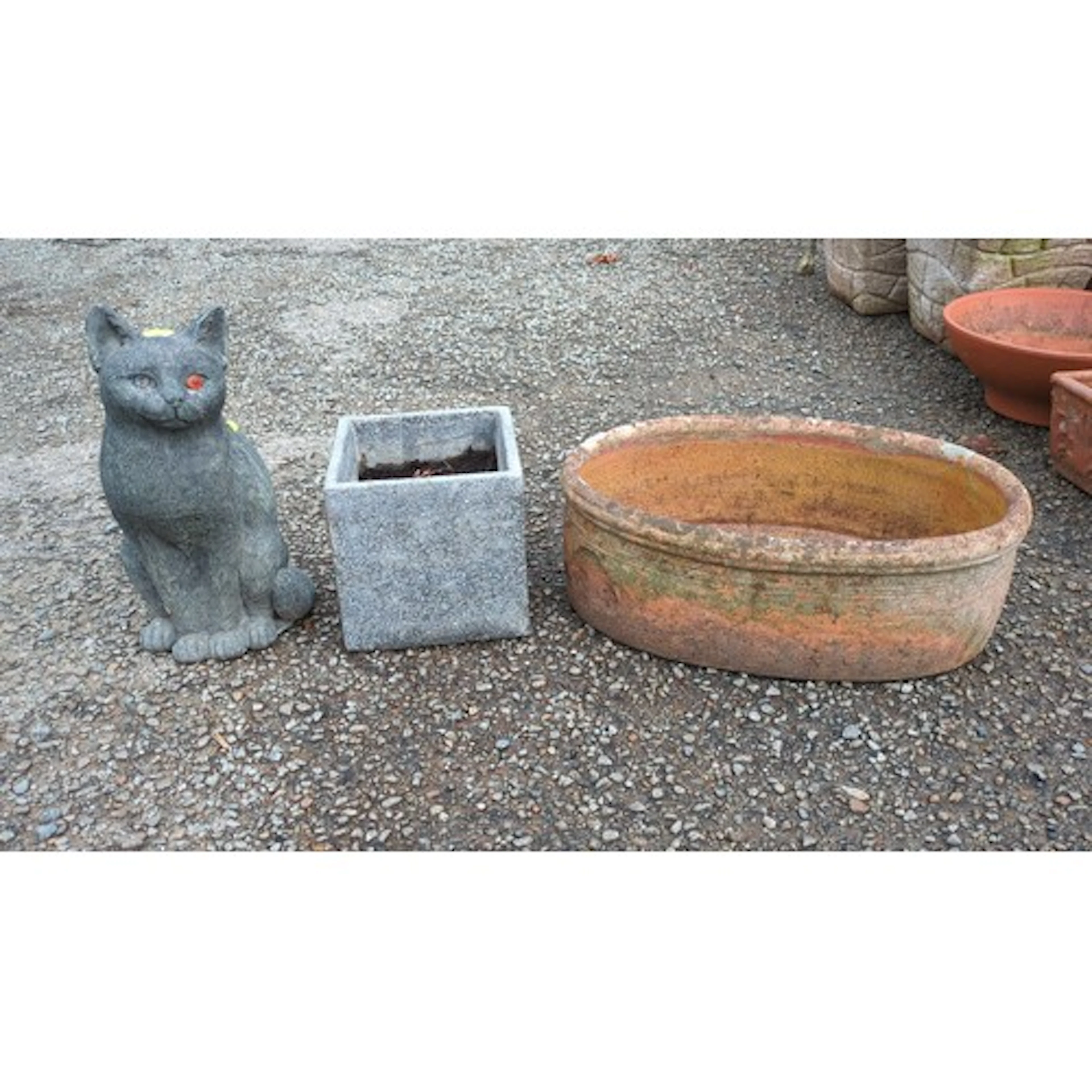 A group of garden ornaments comprising a seated cat figure, ...