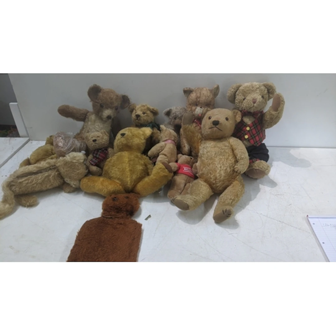 A collection of teddy bears in various sizes and attire Loca...