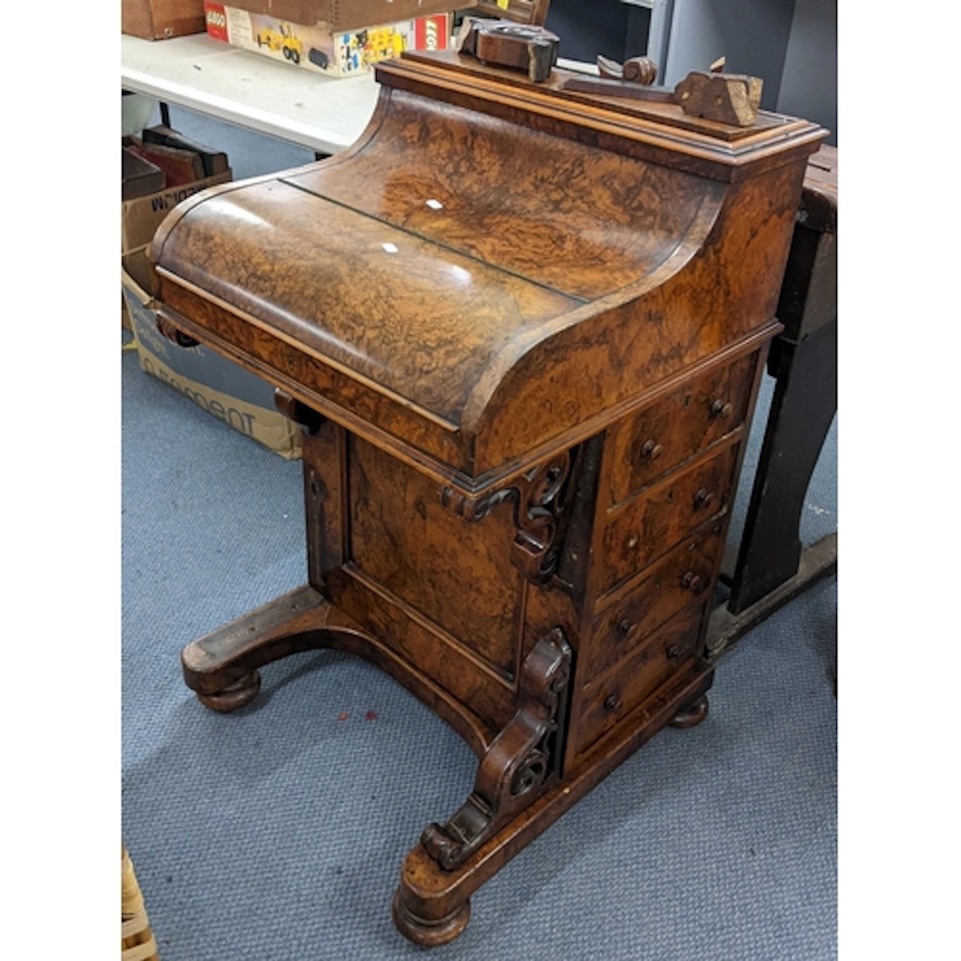 A Victorian burr walnut piano-topped Davenport, having a ris...