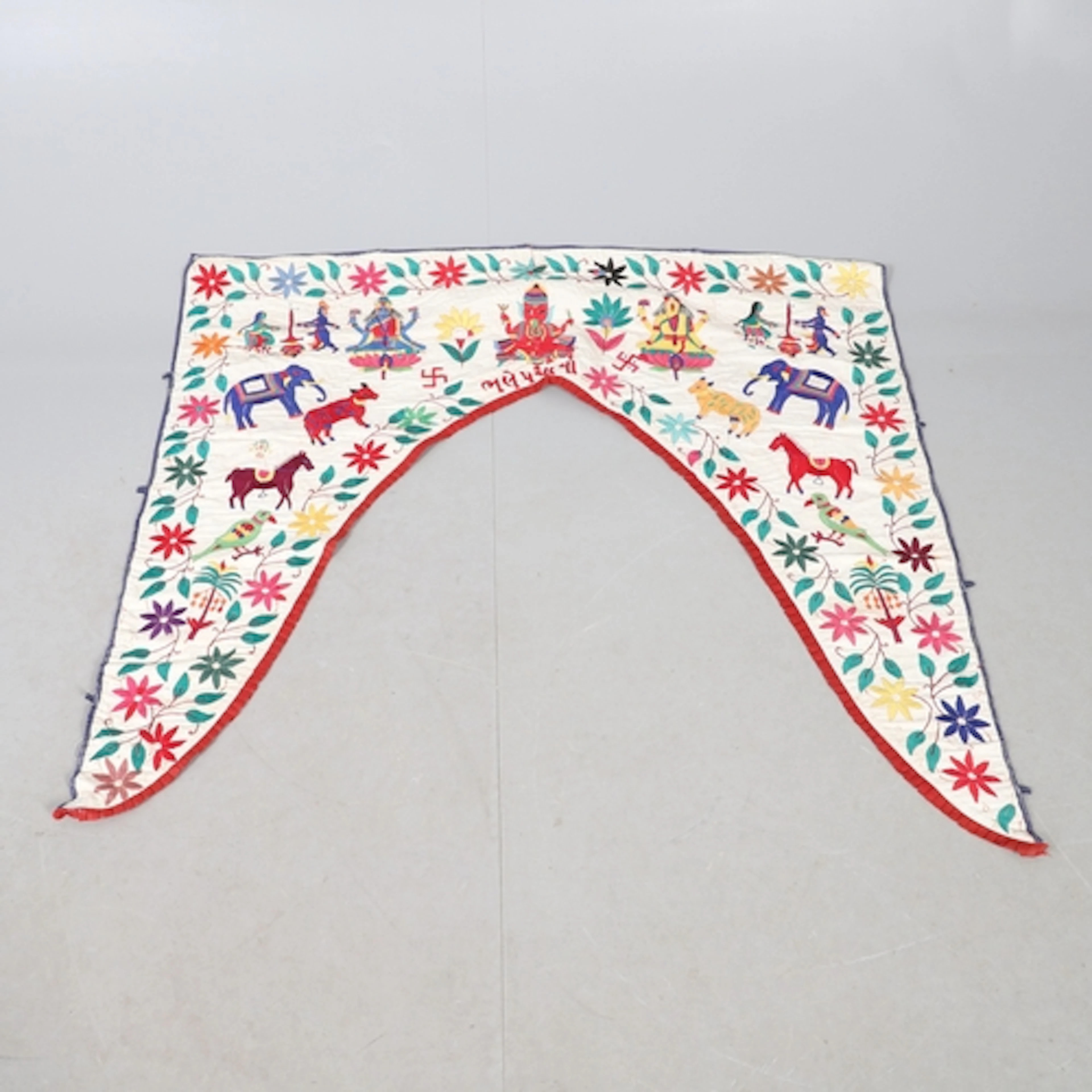 AN INDIAN COTTON DOOR HANGING. possibly a pelmet, early 20th...