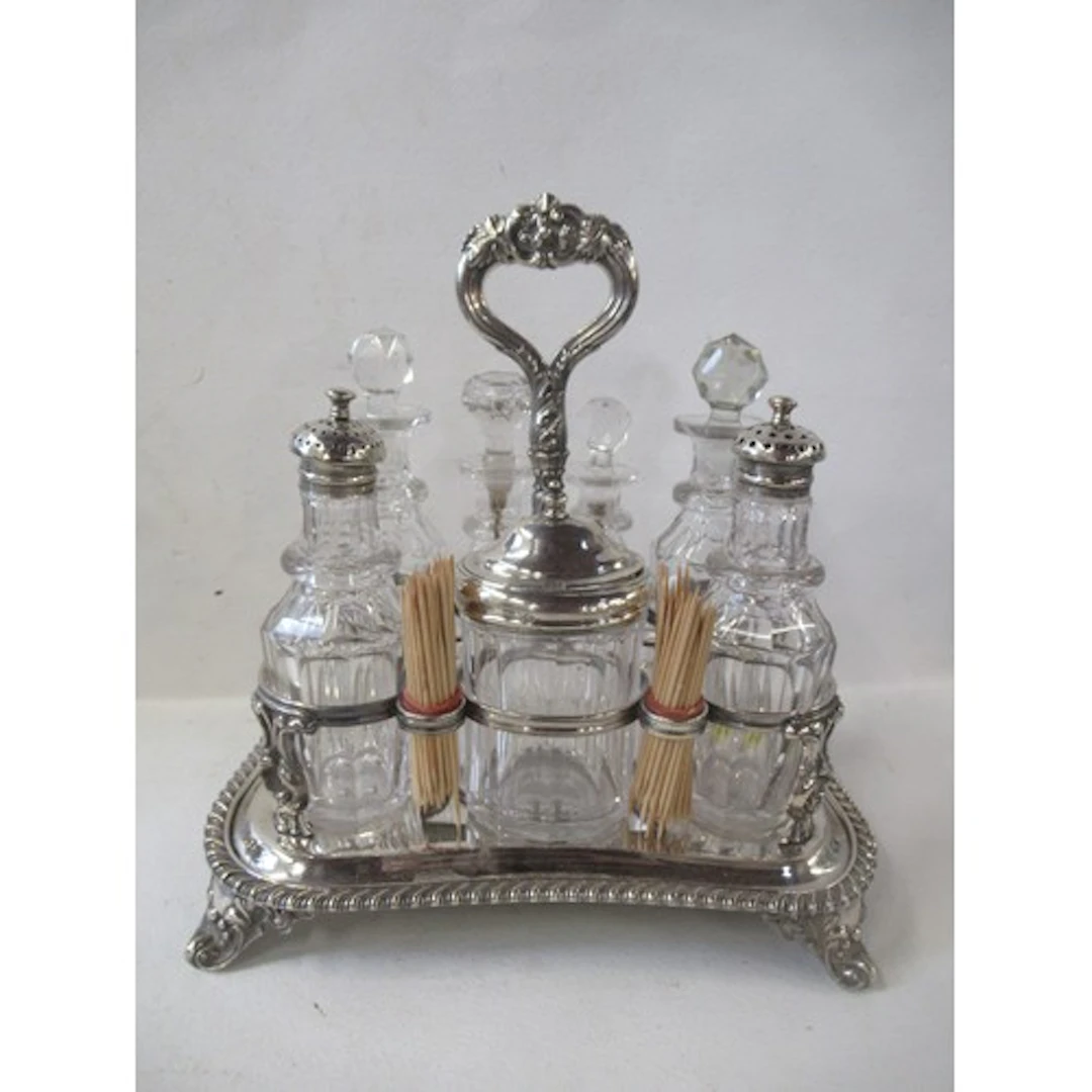 A 19th century silver plated cruet frame, containing seven v...