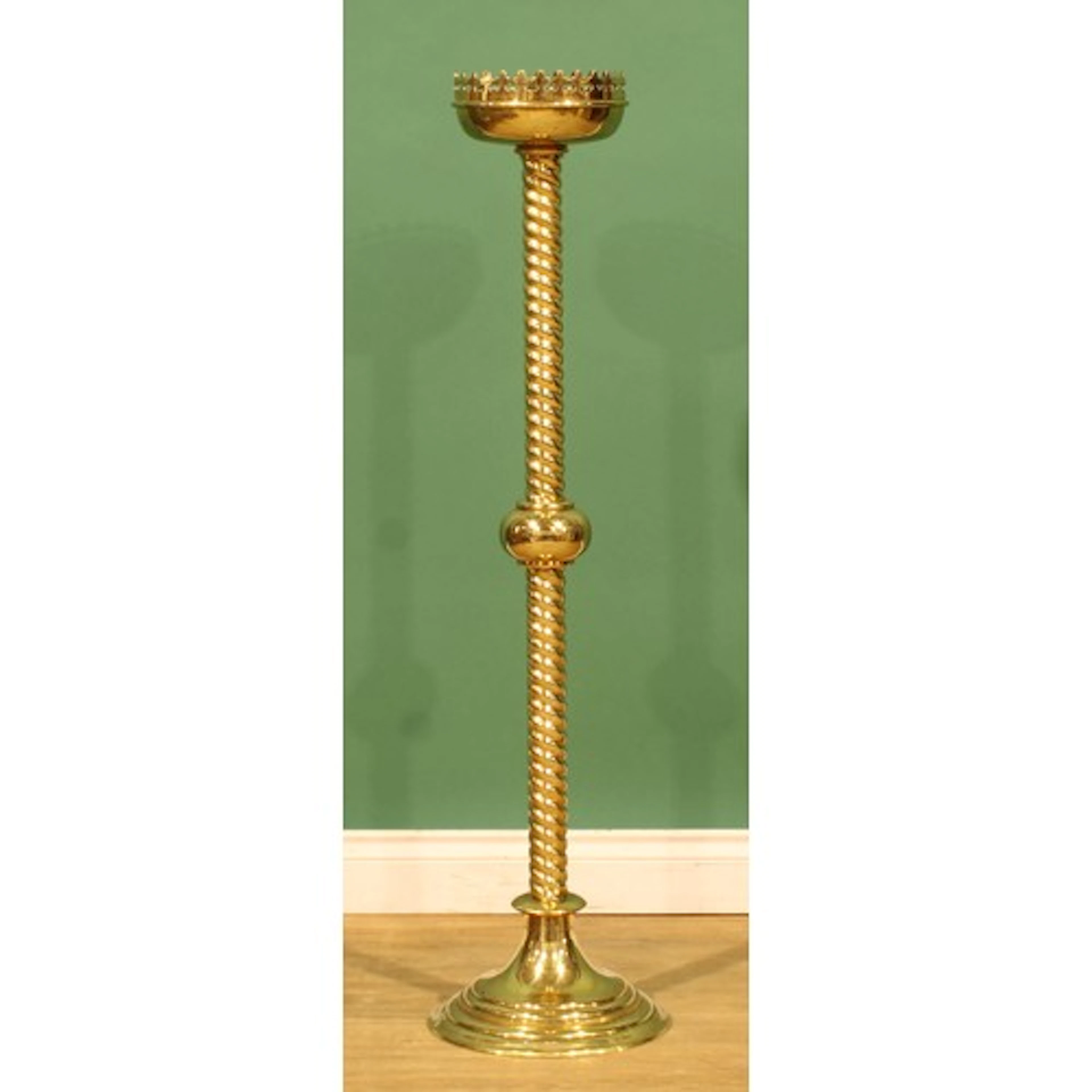 A Gothic Revival style brass floor-standing pricket candlest...