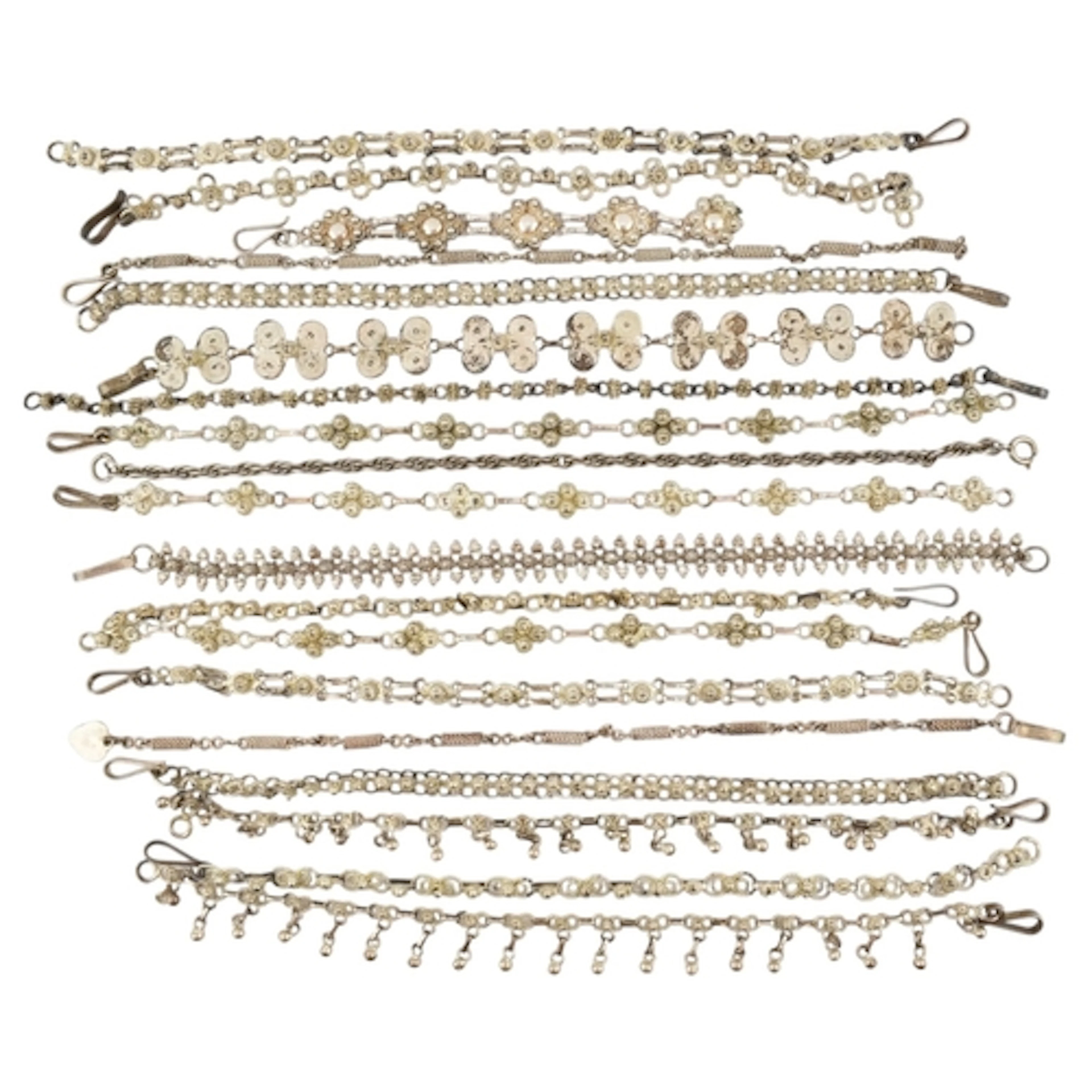 Collection of silver and white metal filigree bracelets. To ...