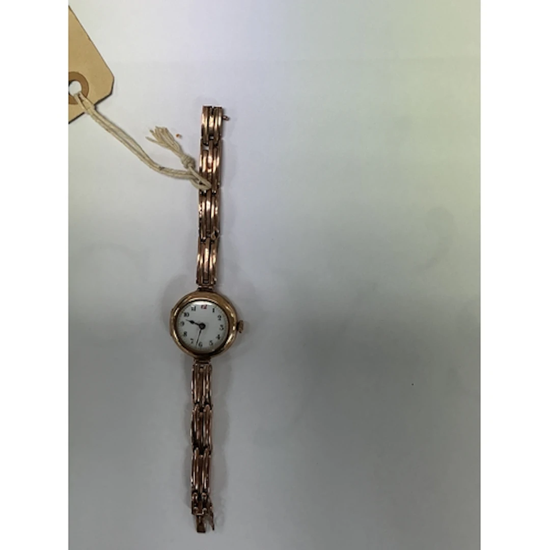 A vintage 9ct gold ladies wristwatch on articulated gold str...