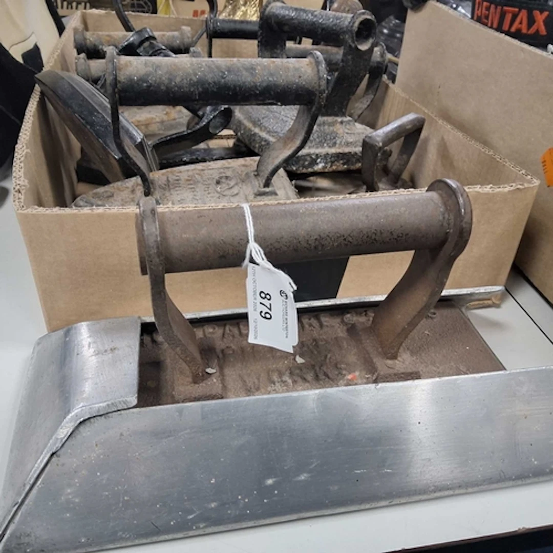 A GROUP OF METAL IRONS to include a Padmore & Sons of Bi...