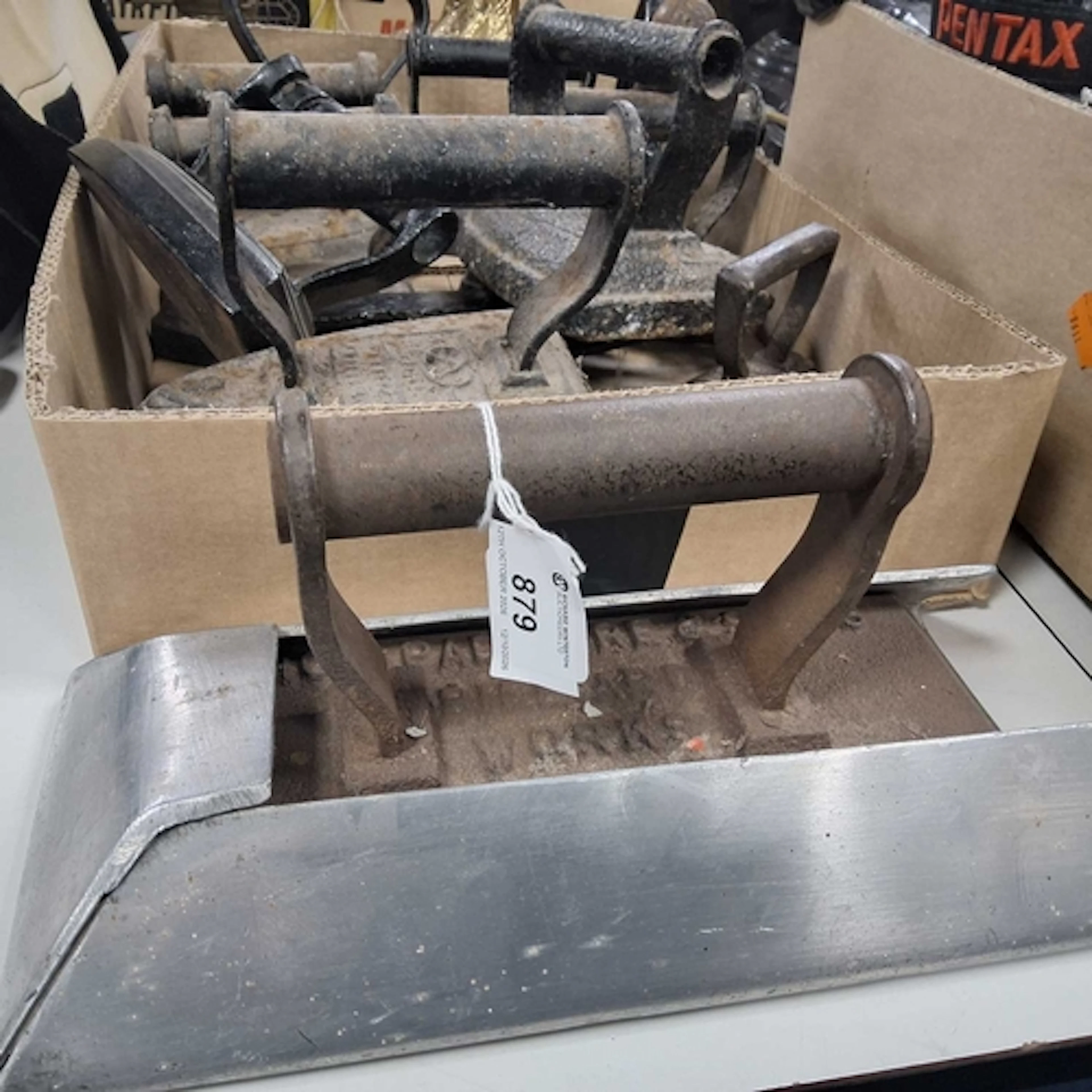 A GROUP OF METAL IRONS to include a Padmore & Sons of Bi...