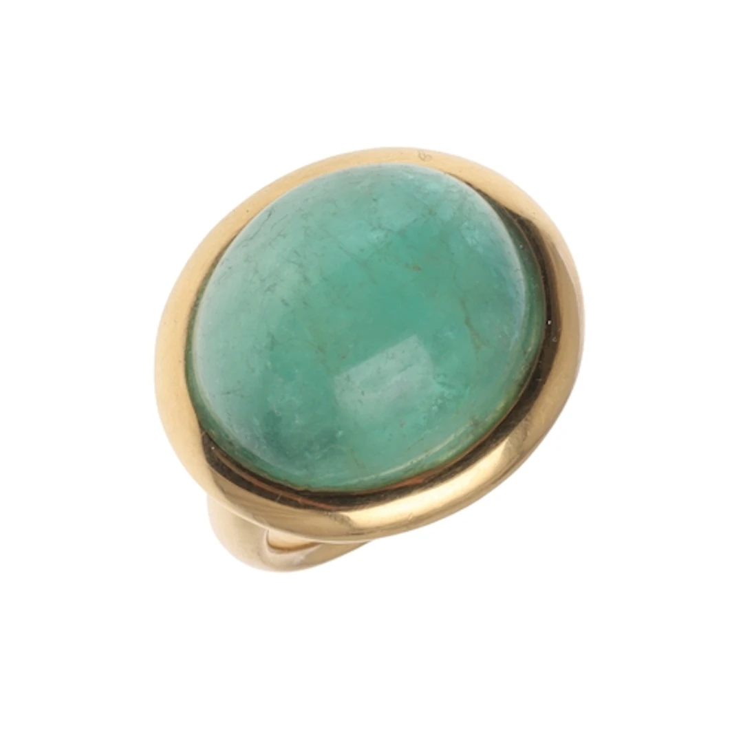 AN EMERALD AND 18CT GOLD RING BY TAYMA. mounted with a caboc...