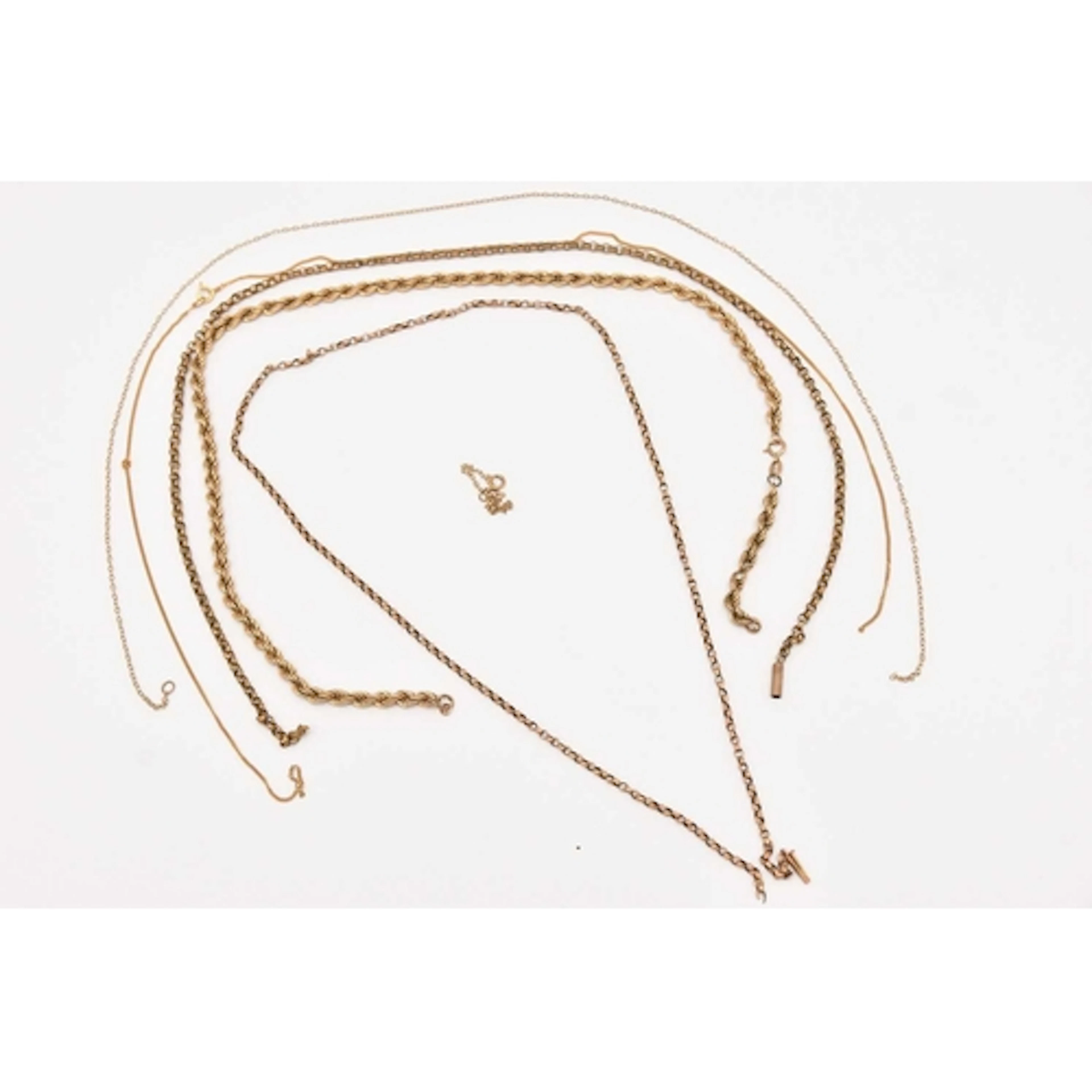 AN ASSORTMENT OF BROKEN 9CT AND YELLOW METAL CHAINS, a 9ct y...
