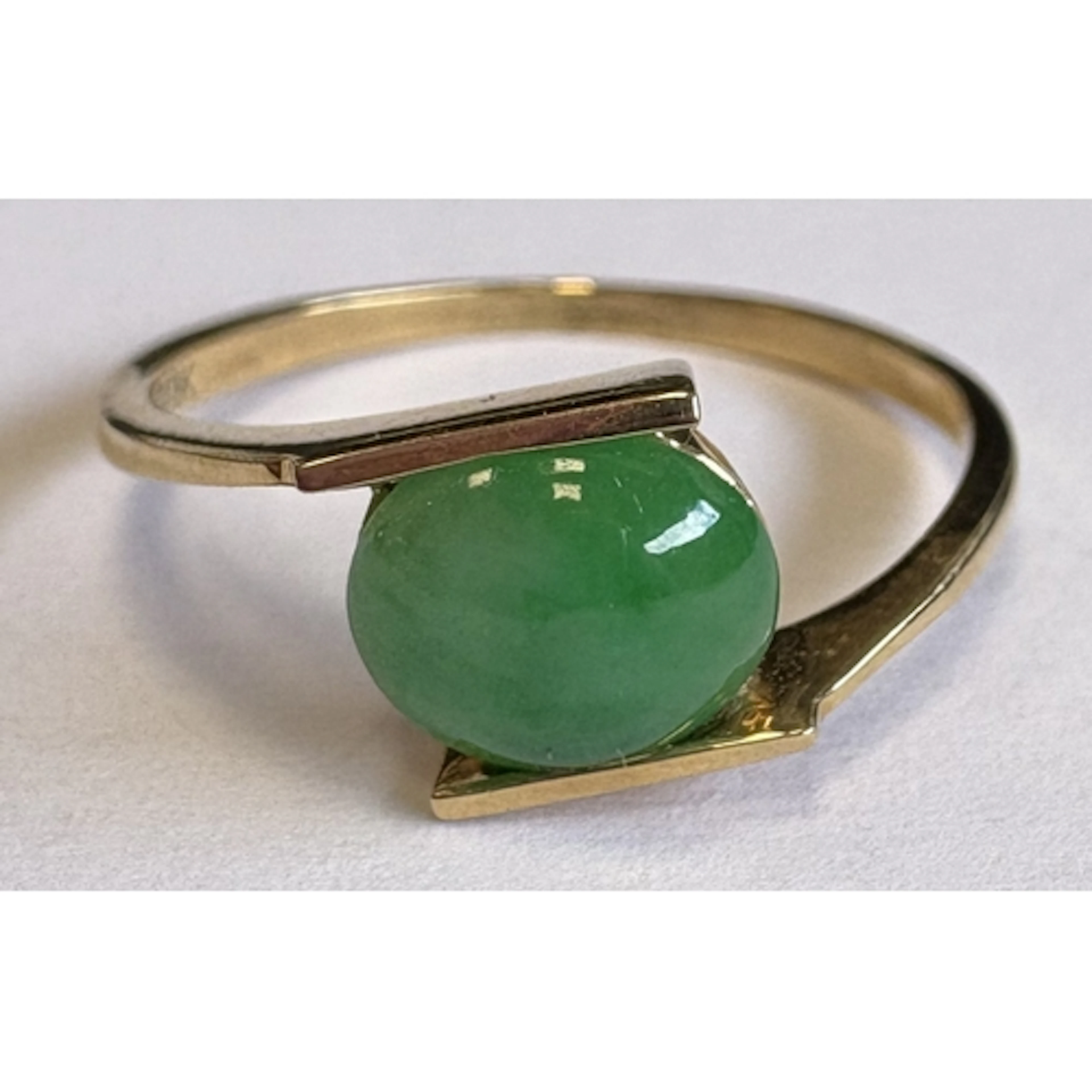 An 18 carat gold jade-set ring. Approx. ring size K. Approx....