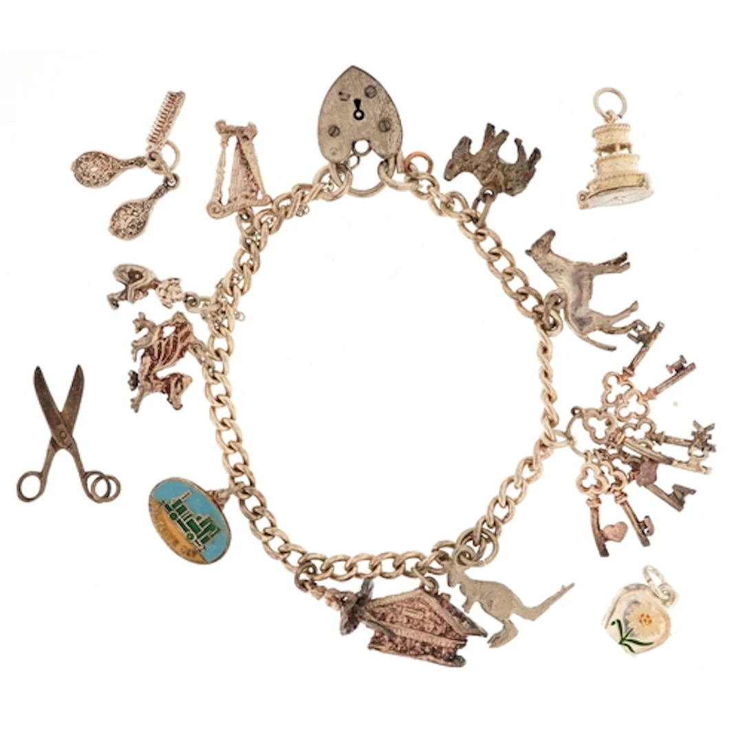 Silver charm bracelet with a large selection of mostly silve...